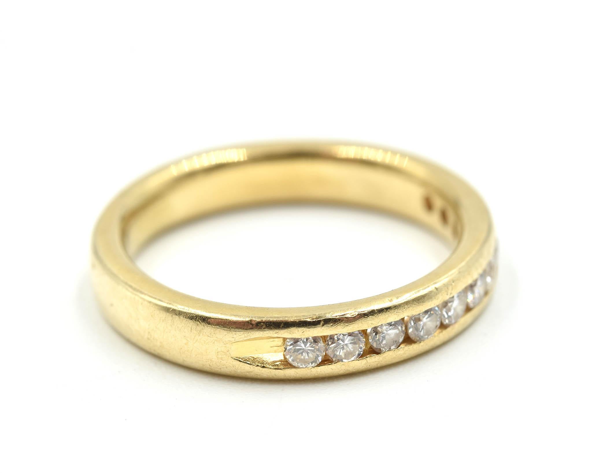 This classic band is made in 14k yellow gold and set with round diamonds. The diamonds have a total weight of 0.33 carats. The band weighs 3.00 grams. It is size 6.