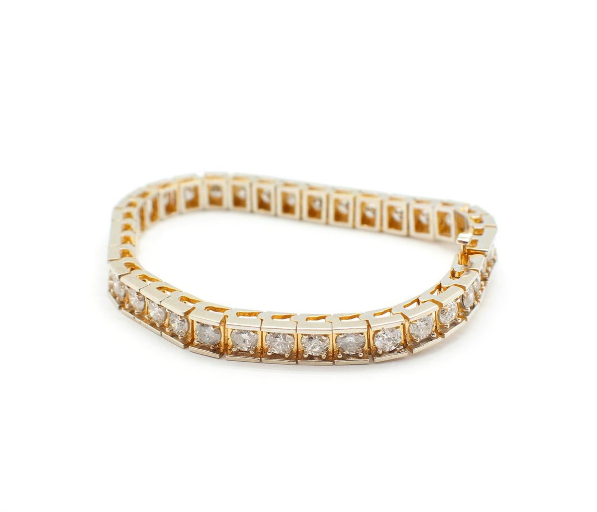 This stylish bracelet is designed with 14k yellow gold. Set in each square link, are round diamonds. The diamonds are held in place by 4 gold prongs. In total the 36 diamonds have 7.70cttw, they are H-I in color, and I1 in clarity. The bracelet has