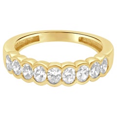 14 Karat Yellow Gold and 9-Stone Half Bezel Set Oval Cut Diamond Band
