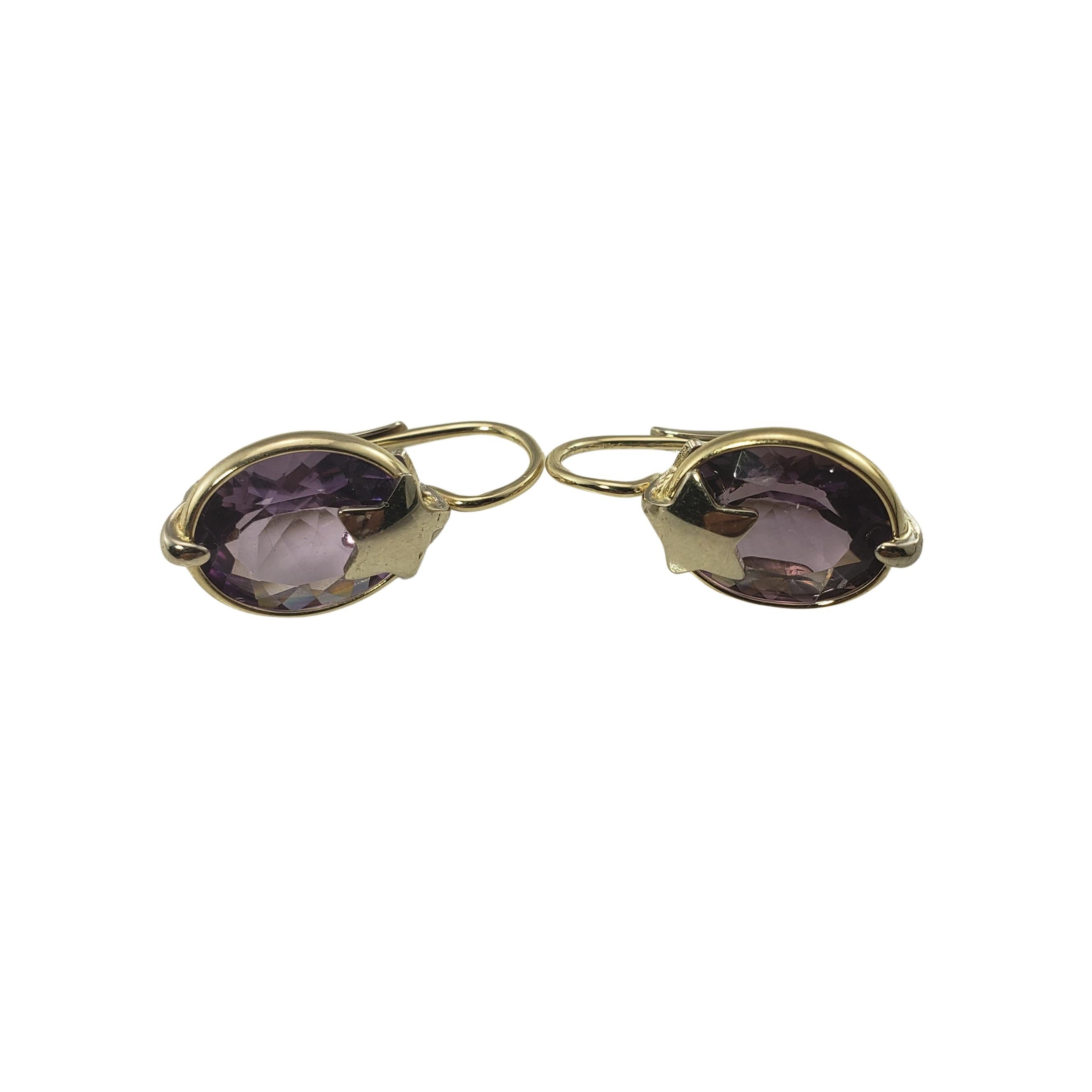 14 Karat Yellow Gold and Amethyst Earrings GAI Certified-

These lovely hinged earrings each feature one oval amethyst (15 mm x 11 mm each) set in beautifully detailed 14K yellow gold. 

Amethyst total weight:  9.74 ct..

Size: 22 mm x 11