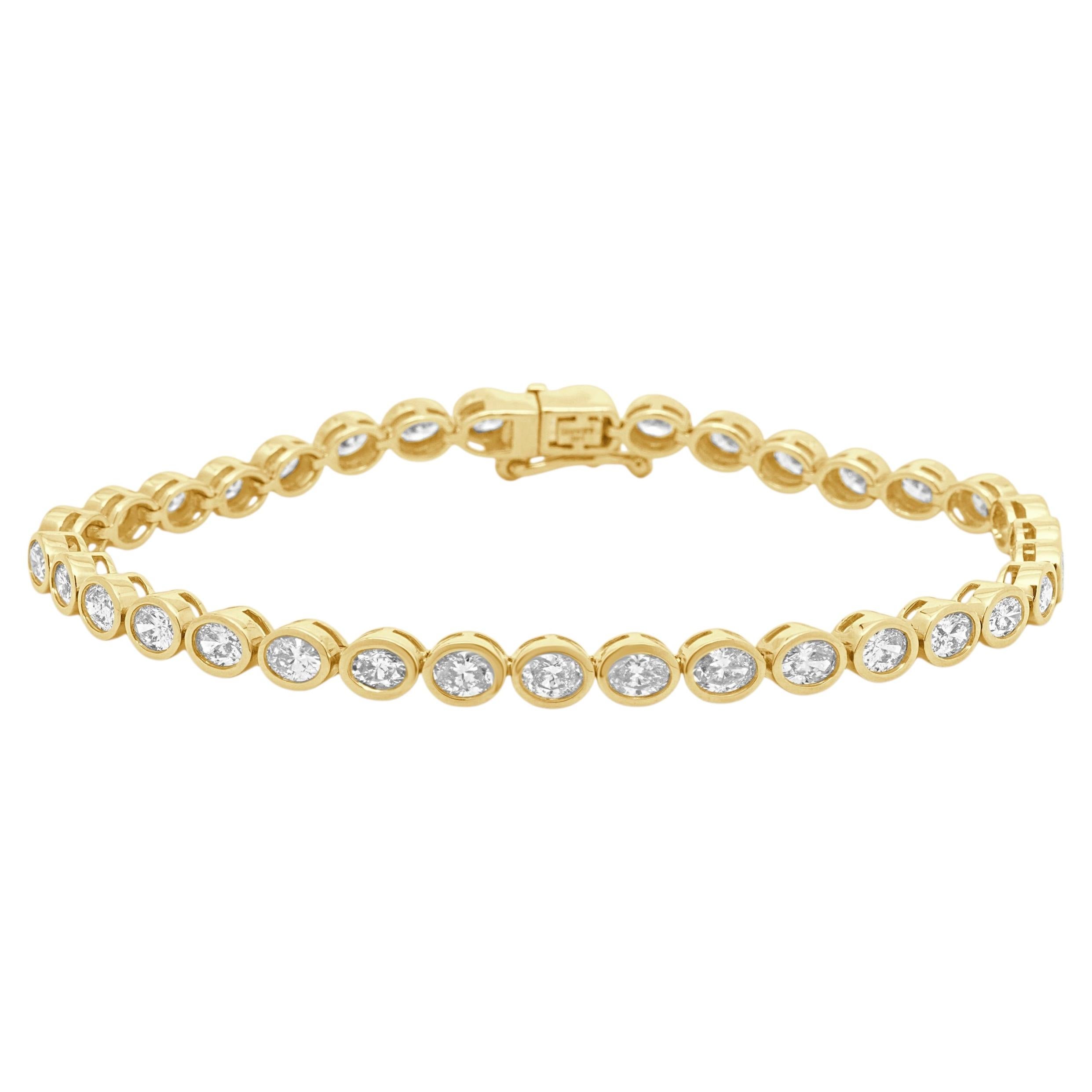 14 Karat Yellow Gold and Bezel Set Oval Cut Diamond Inline Bracelet For Sale