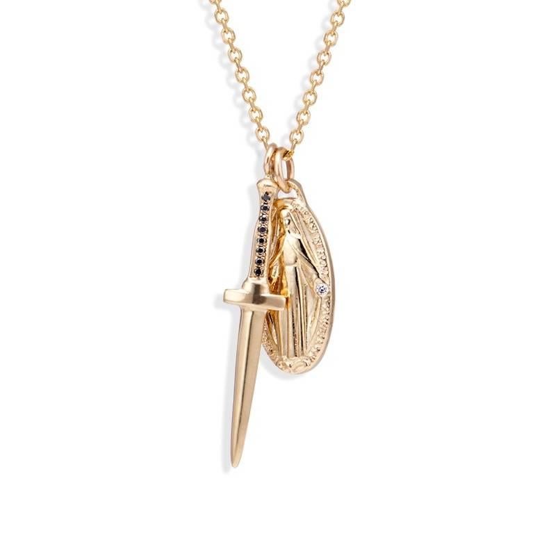 The 14k gold dagger pendant with eight black diamonds set in the handle is a best-seller among men and women.  It is lightweight but still substantial enough to be worn solo. It was modeled after Gothic daggers and is the perfect accompaniment to