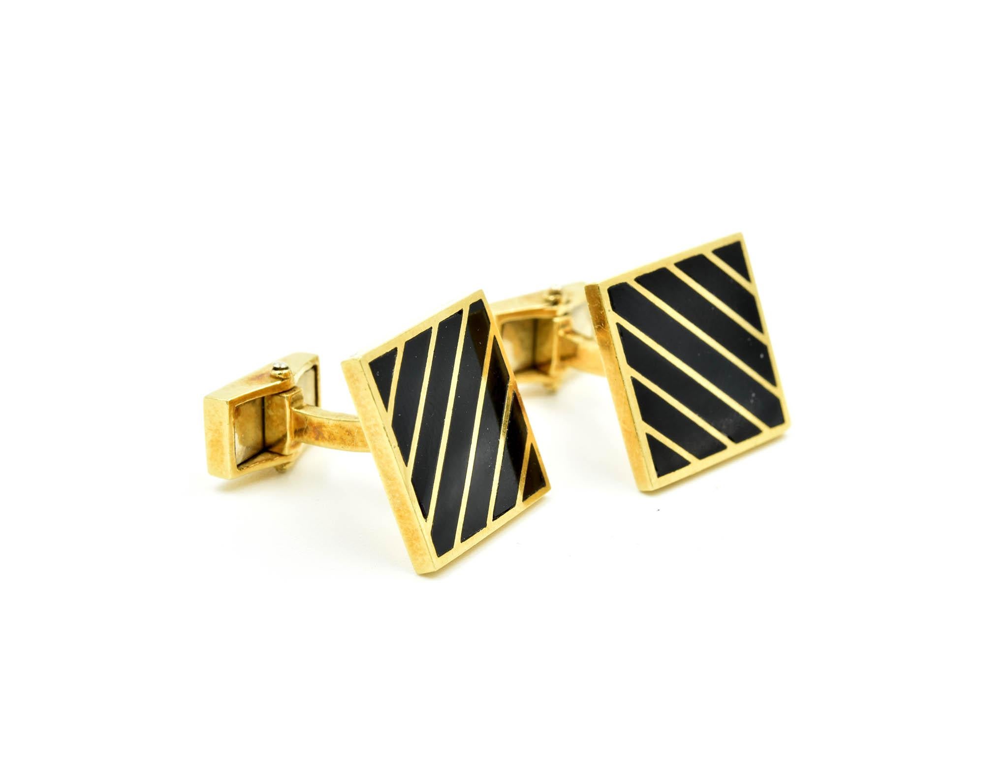 This handsome pair of cufflinks is made in 14k yellow gold with black onyx set diagonally across the top. The face of the cufflinks 15.90mm in diameter and total weight is 14.30 grams. Each cufflink is fastened with a toggle to securely fit the