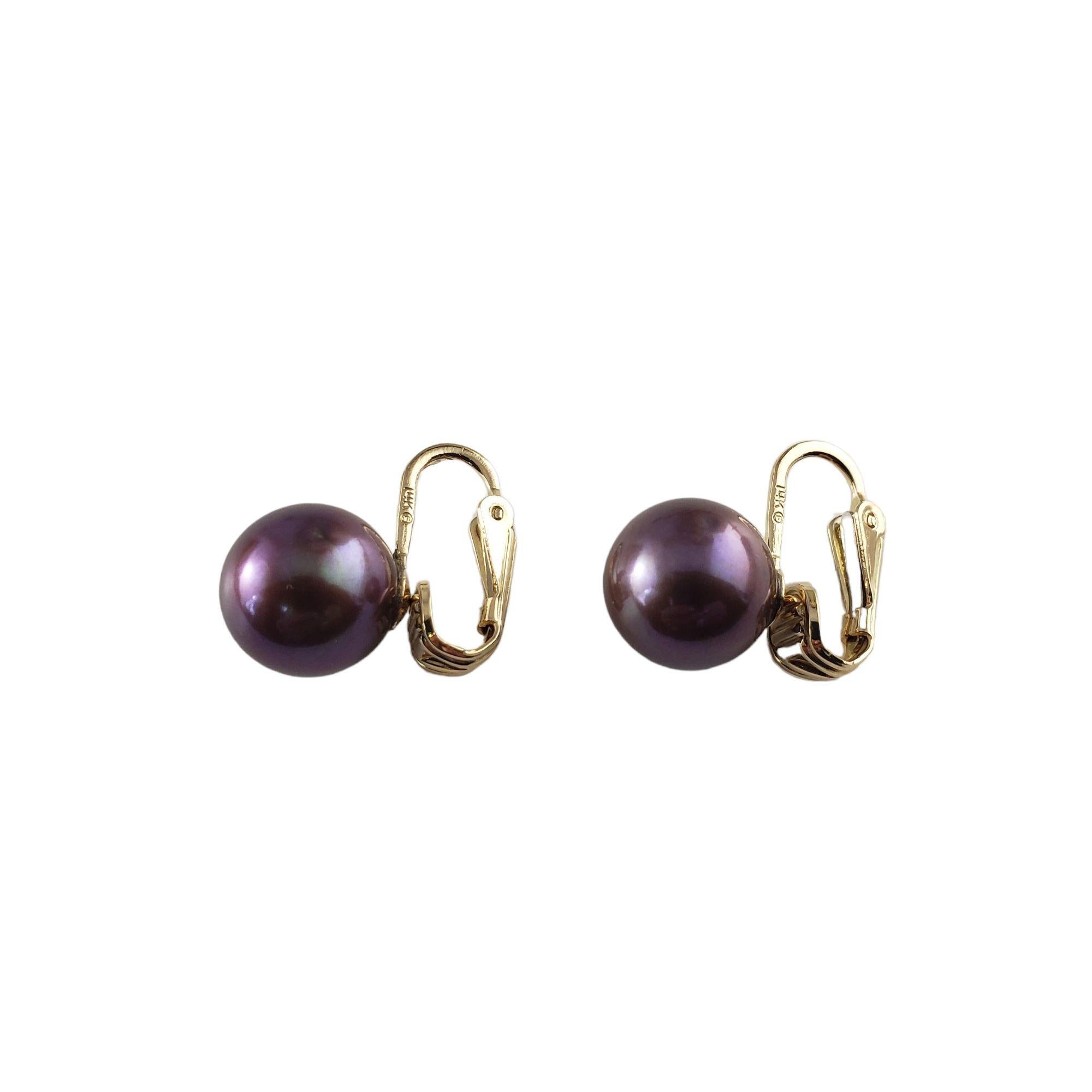 Vintage 14 Karat Yellow Gold and Black Pearl Clip On Earrings-

These lovely earrings each feature one black pearl (11 mm) set in classic 14K yellow gold. Clip on closures.

Size: 17 mm x 11 mm

Weight: 3.4 dwt. / 5.3 gr.

Stamped: 14K

Very good