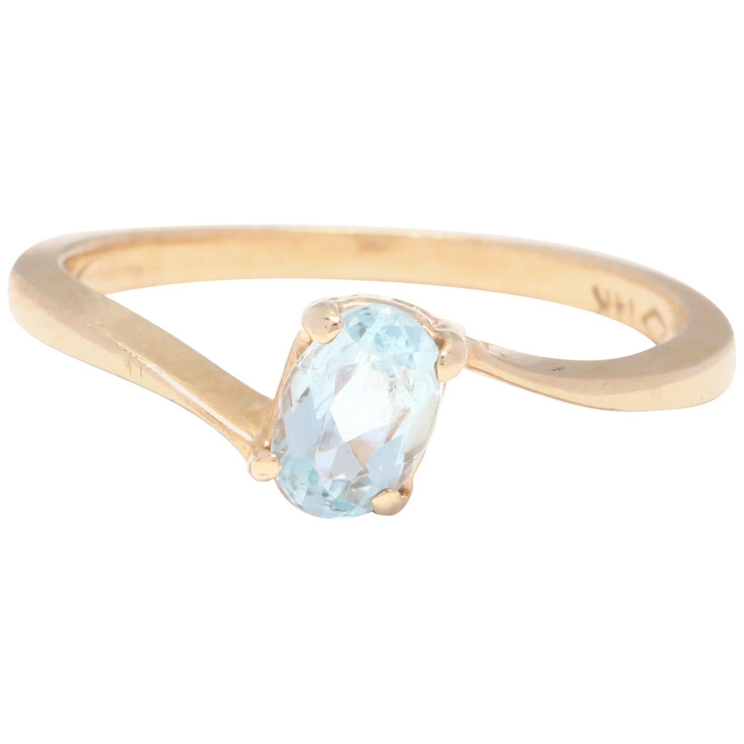 14 Karat Yellow Gold and Blue Topaz Bypass Solitaire Ring