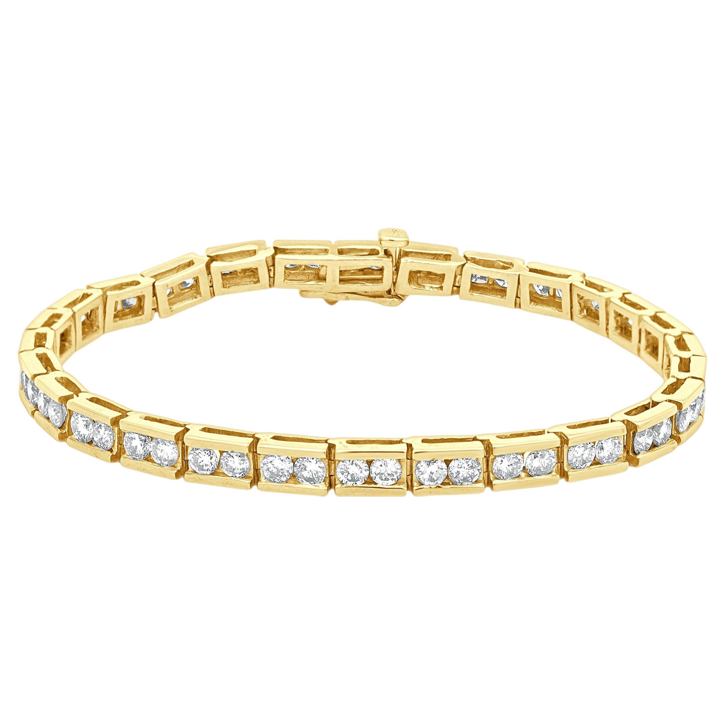 Pulsera en línea de oro amarillo de 14 quilates y diamantes redondos engastados en canal