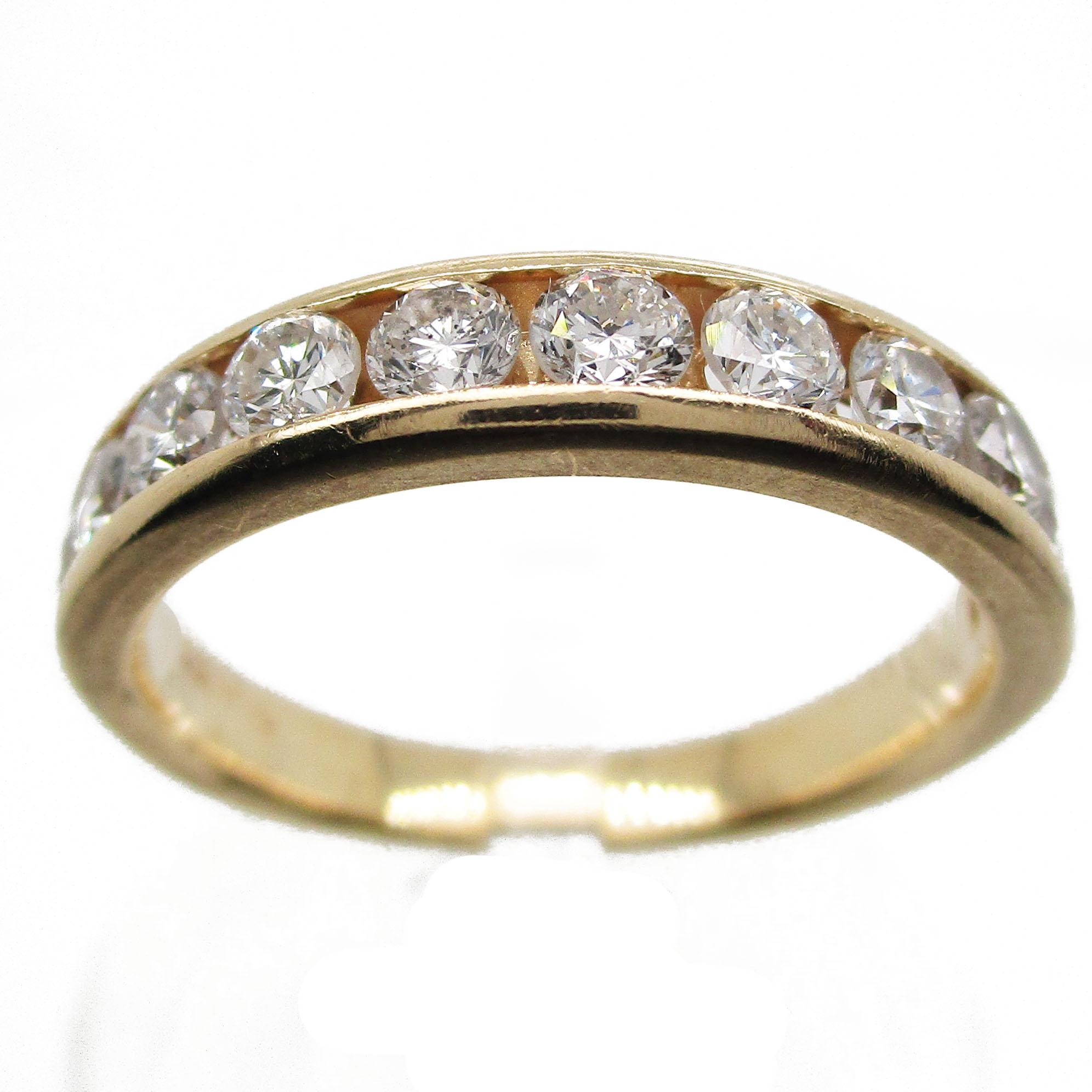 This gorgeous contemporary ring features a brilliant, rich 14 karat yellow gold band and eleven stunning channel set round cut diamonds with a total weight of 1.10 carats. This ring represents phenomenal value! The channel setting of the diamonds