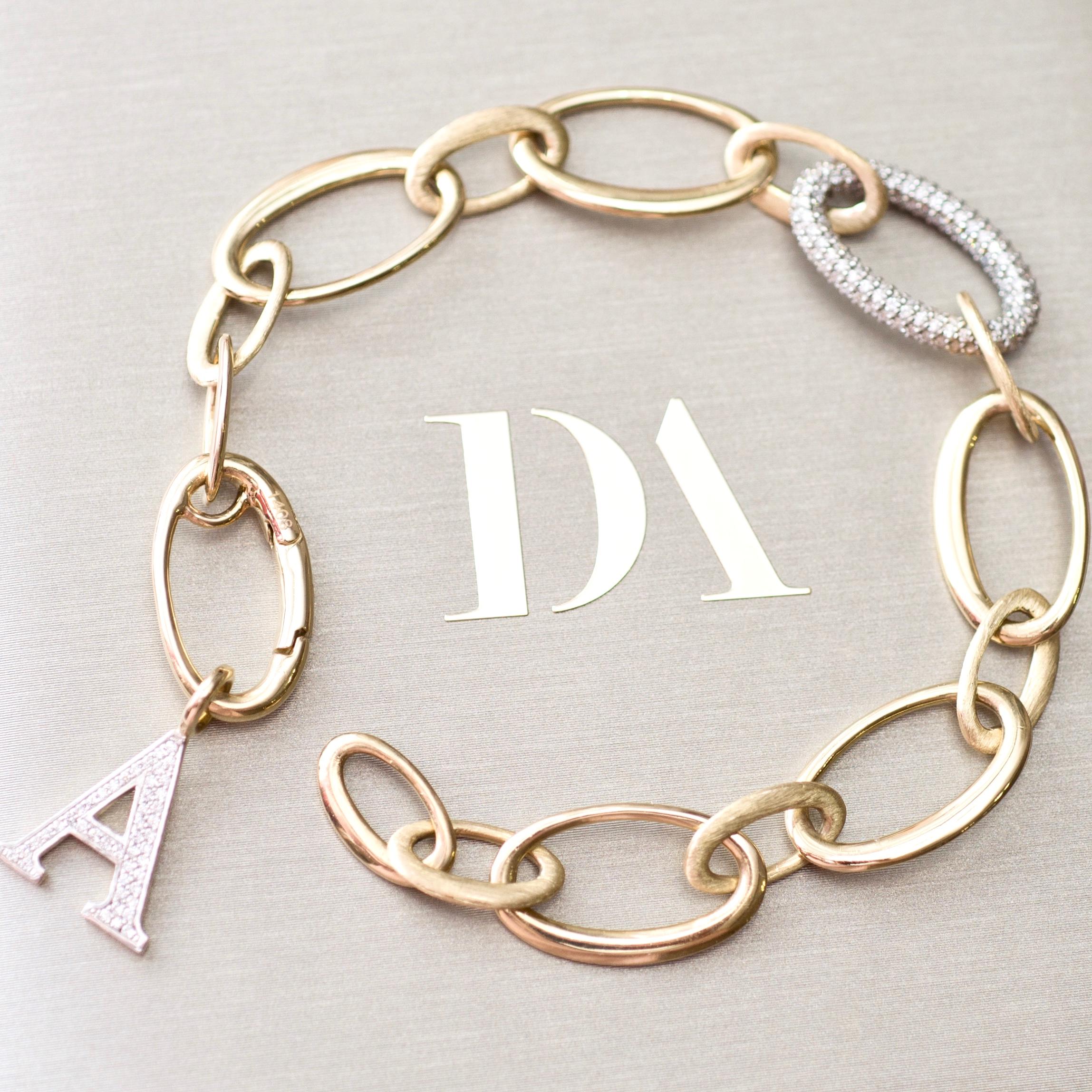 Do you like bracelets? If so, we have one very very stylish option for you. 
Everything is beautiful here - matte and bright gold, shape, diamonds and unusual modern lock. 
This bracelet will be ideal for someone who does not like standard things