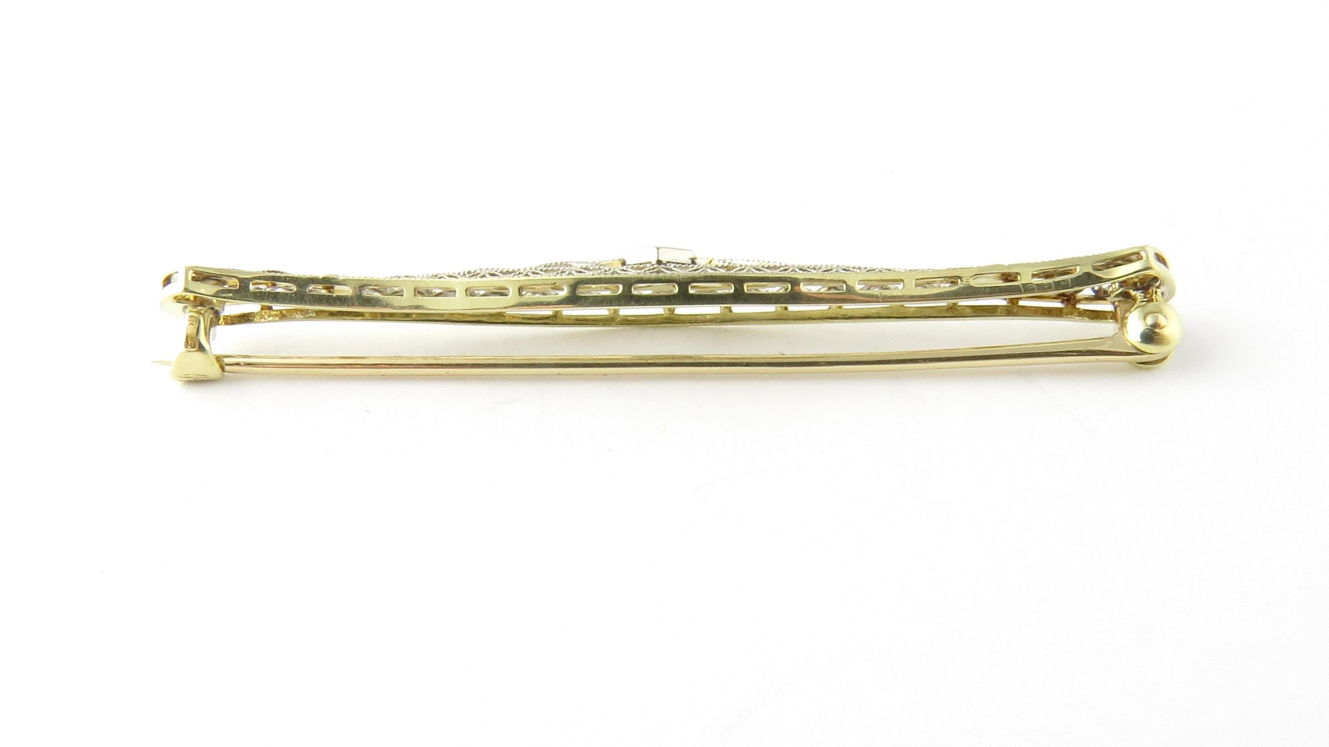 Vintage 14 Karat Yellow and White Gold and Diamond Brooch /Pin.

This lovely bar pin features one round brilliant cut diamond set in elegant yellow and white gold filigree.

Approximate total diamond weight: .10 ct.

Diamond color: G

Diamond