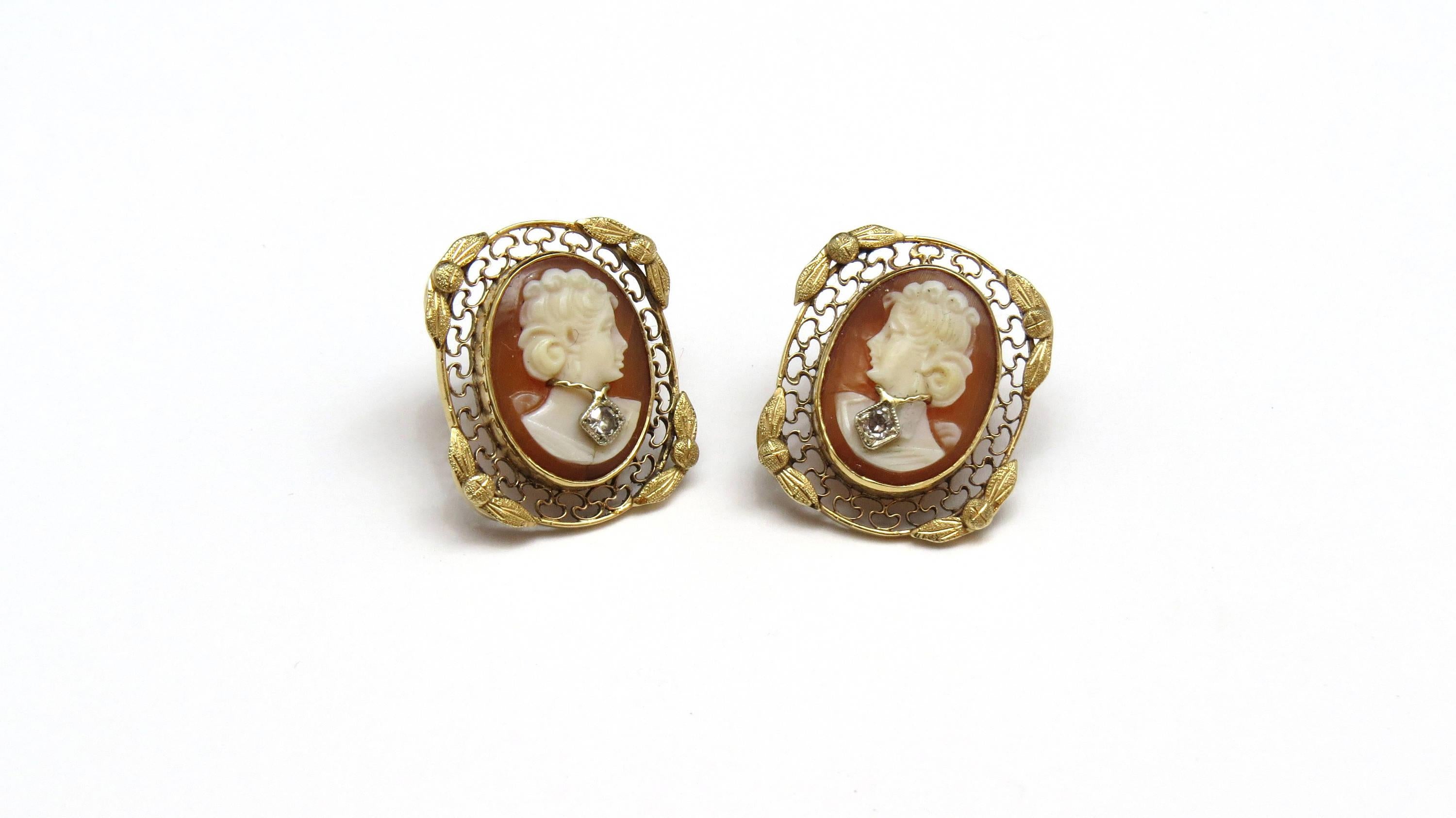 Vintage 14K Yellow Gold and Diamond Cameo Filigree Earrings 
21 mm by 17.5 mm 
4.4 dwt /6.9 g 
Necklace on the cameo contains a single cut diamond of about .02cts 
Screw backs - for pierced ears 
Tested and stamped 14K 
All of our items are packaged