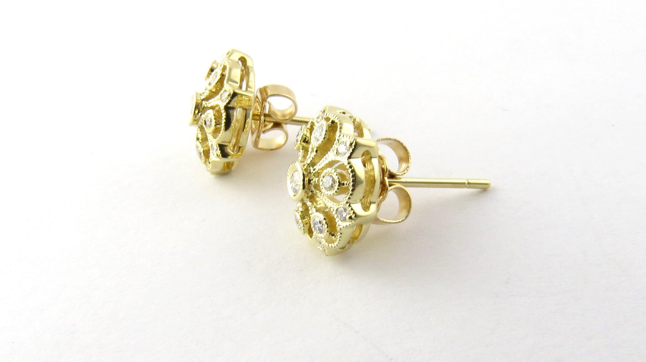 Vintage 14 Karat Yellow Gold and Diamond Earrings-

These elegant earrings each feature 13 round brilliant cut diamonds set in meticulously detailed 14K yellow gold. Push back closures.

Approximate total diamond weight: .42 ct.

Diamond color: