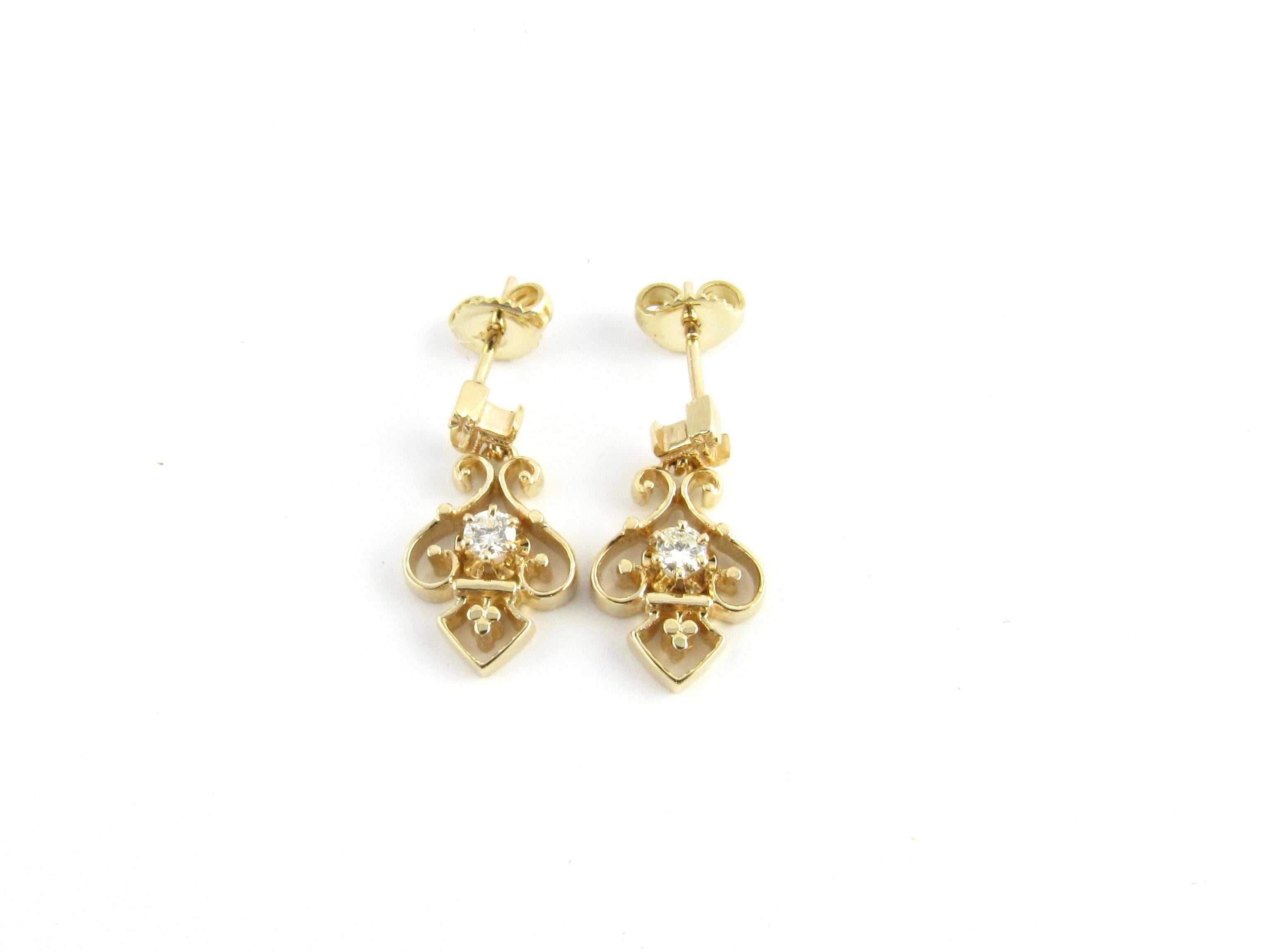 Vintage 14 Karat Yellow Gold and Diamond Earrings-

These lovely dangle earrings each feature one round brilliant cut diamond set in beautifully detailed 14K yellow gold.  
Push back closures.

Approximate total diamond weight:  .10 ct.

Diamond