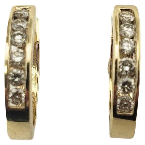 Vintage 14 Karat Yellow Gold and Diamond Hoop Earrings-

These sparkling hoop earrings each feature 12 round brilliant cut diamonds set in classic 14K yellow gold.

Approximate total diamond weight: .48 ct.

Diamond clarity: VS1-SI2

Diamond color: