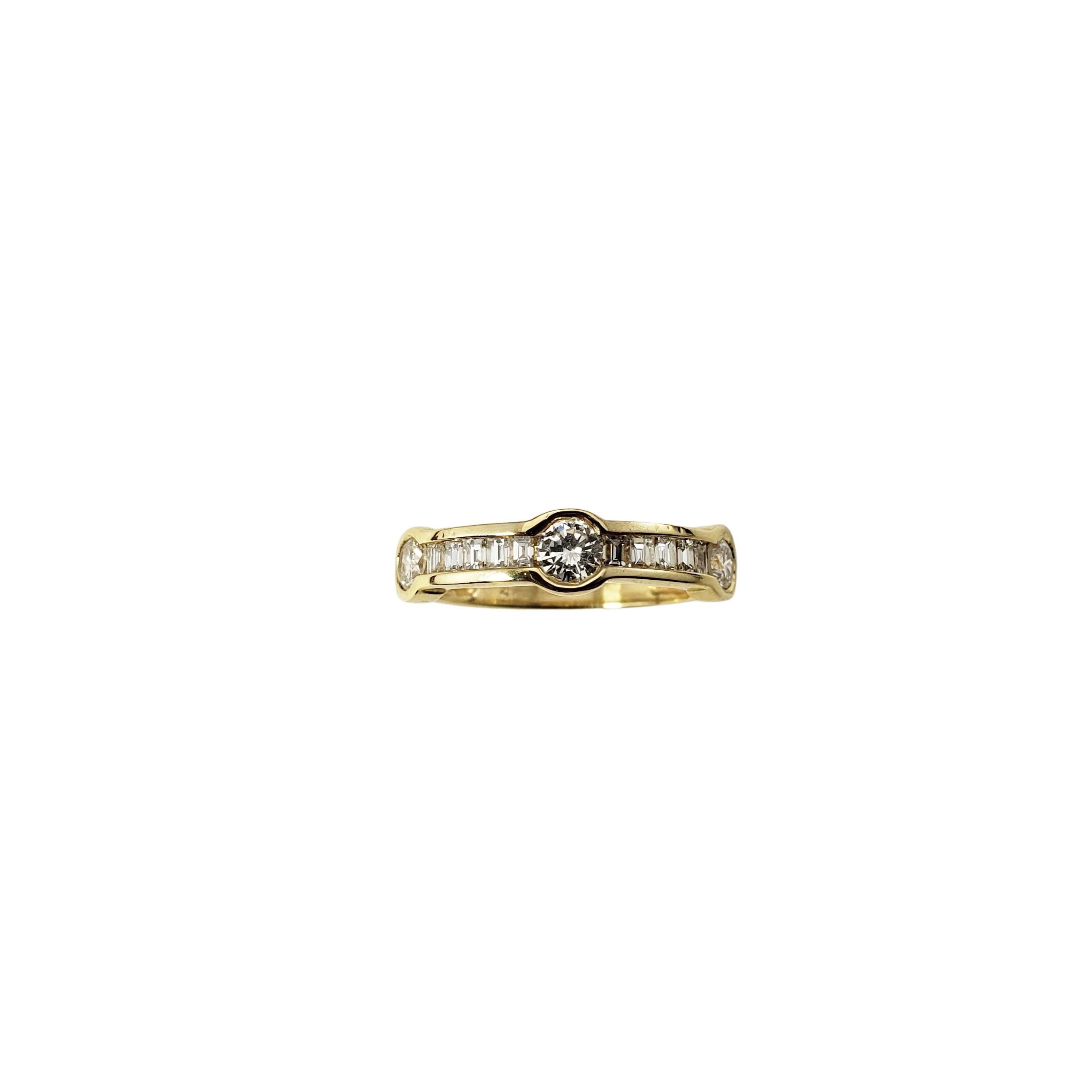 14 Karat Yellow Gold and Diamond Ring Size 6-

This sparkling ring features 10 baguette diamonds and three round brilliant cut diamonds set in beautifully detailed 14K yellow gold.
Width:  5 mm.  Shank:  2 mm.

Approximate total diamond weight:  .70