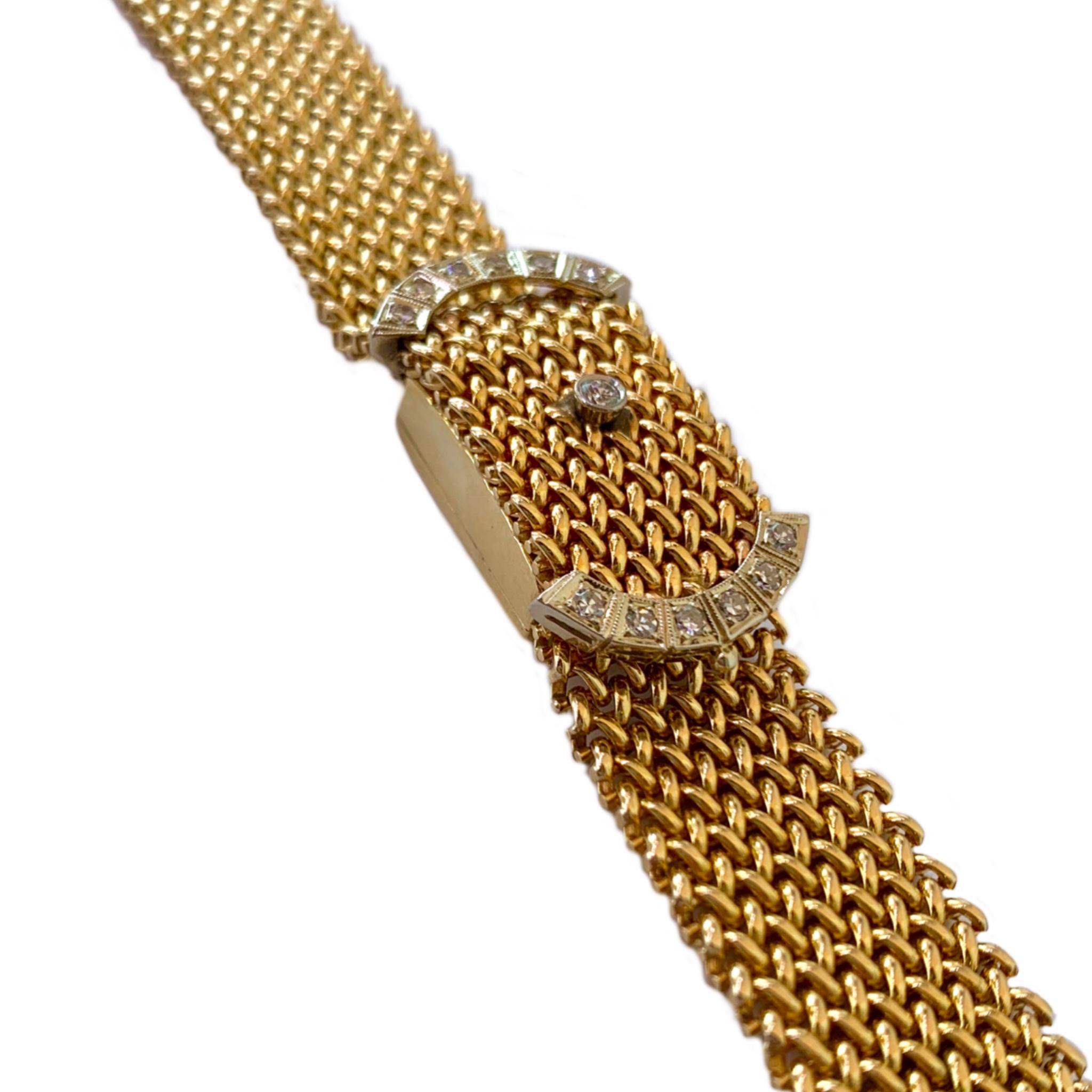 A Hamilton 14 karat yellow gold and diamond vintage bracelet watch. The polished and flexible mesh bracelet is accented with 13 diamonds containing a total weight of approximately .45 carats. The 1960's designed bracelet watch has a 16 mm wide band,