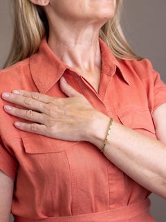 14 Karat Yellow Gold & Emerald Hinged Bangle