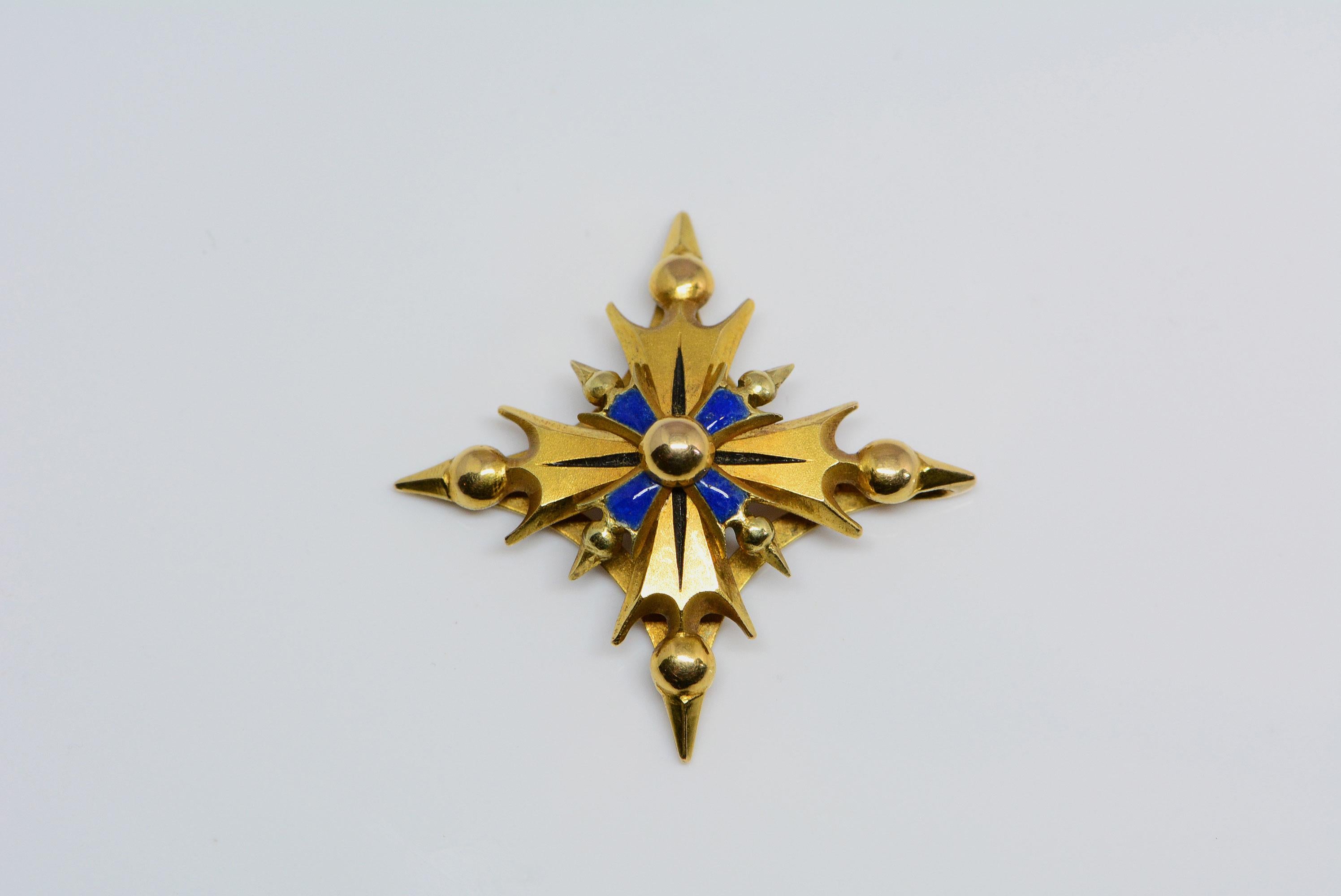 
This pendant has blue enamelling that has been applied on top of 14 karat yellow gold. We believe it is in the form of a stylized maltese cross. 
There is a spot on the back where you can thread a necklace through and wear it as a pendant.
This