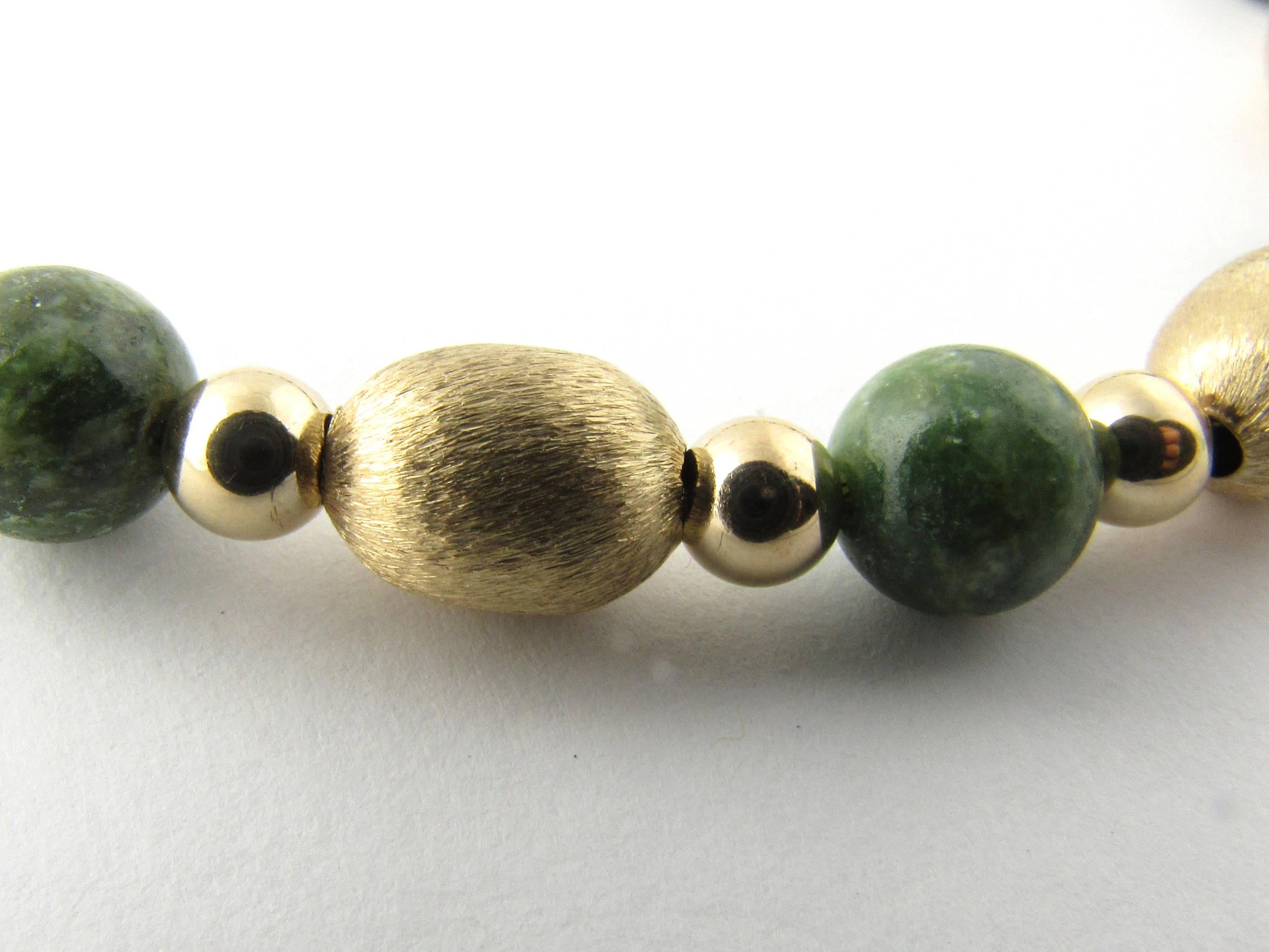 Vintage 14 Karat Yellow Gold and Green Jade Beaded Necklace-

This lovely necklace is beautifully decorated with 14 oval yellow gold beads (10 mm x 7 mm each), 28 round gold beads ( 5 mm each) and 13 round green jade beads (8 mm each). Spring ring