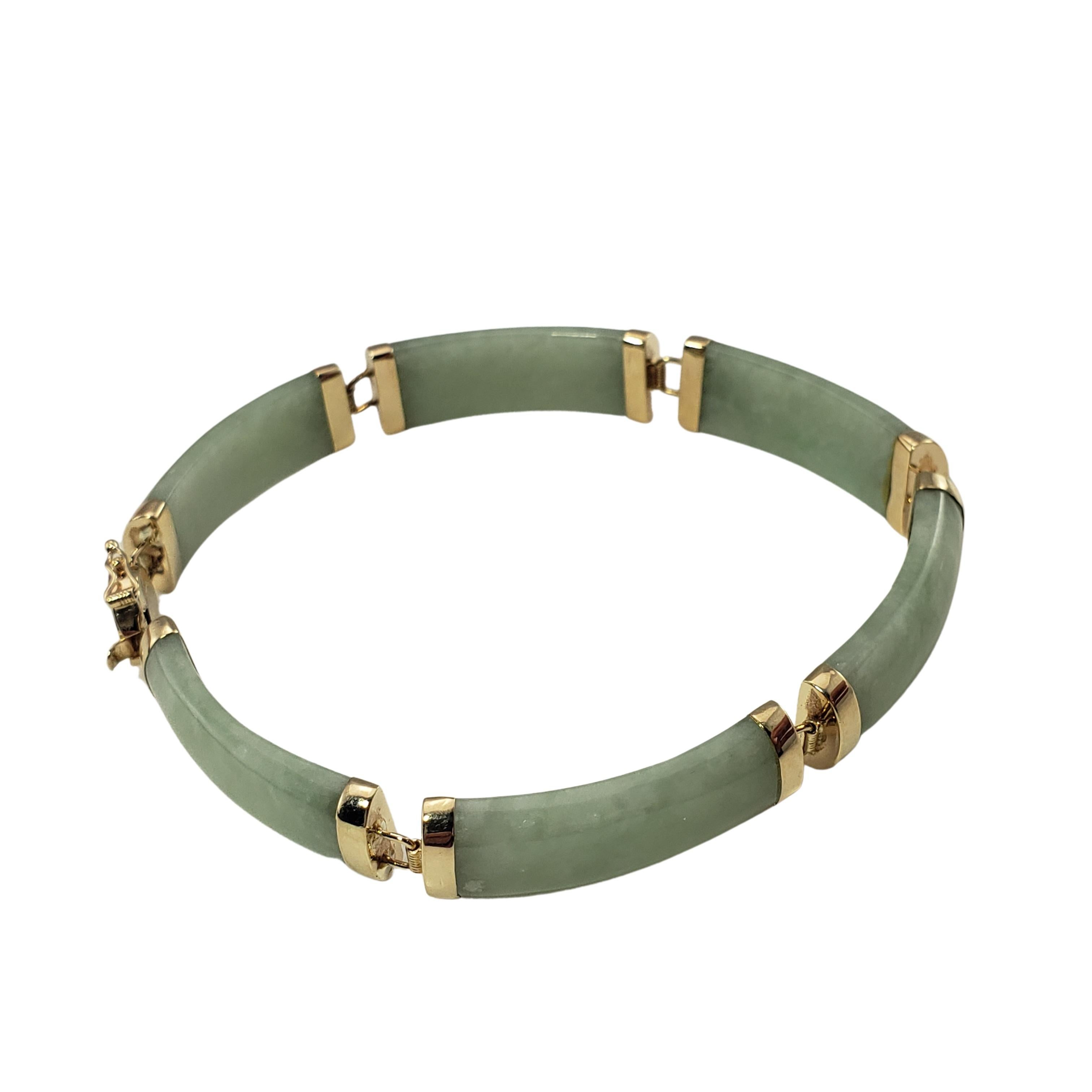 14 Karat Yellow Gold and Jade Bracelet-

This lovely jade bracelet is accented with beautifully detailed 14K yellow gold.  Width:  8 mm.  

Size:  6.5 inches

Weight:   8.7 dwt. /  13.6 gr.

Stamped: 14K  585

Very good condition, professionally