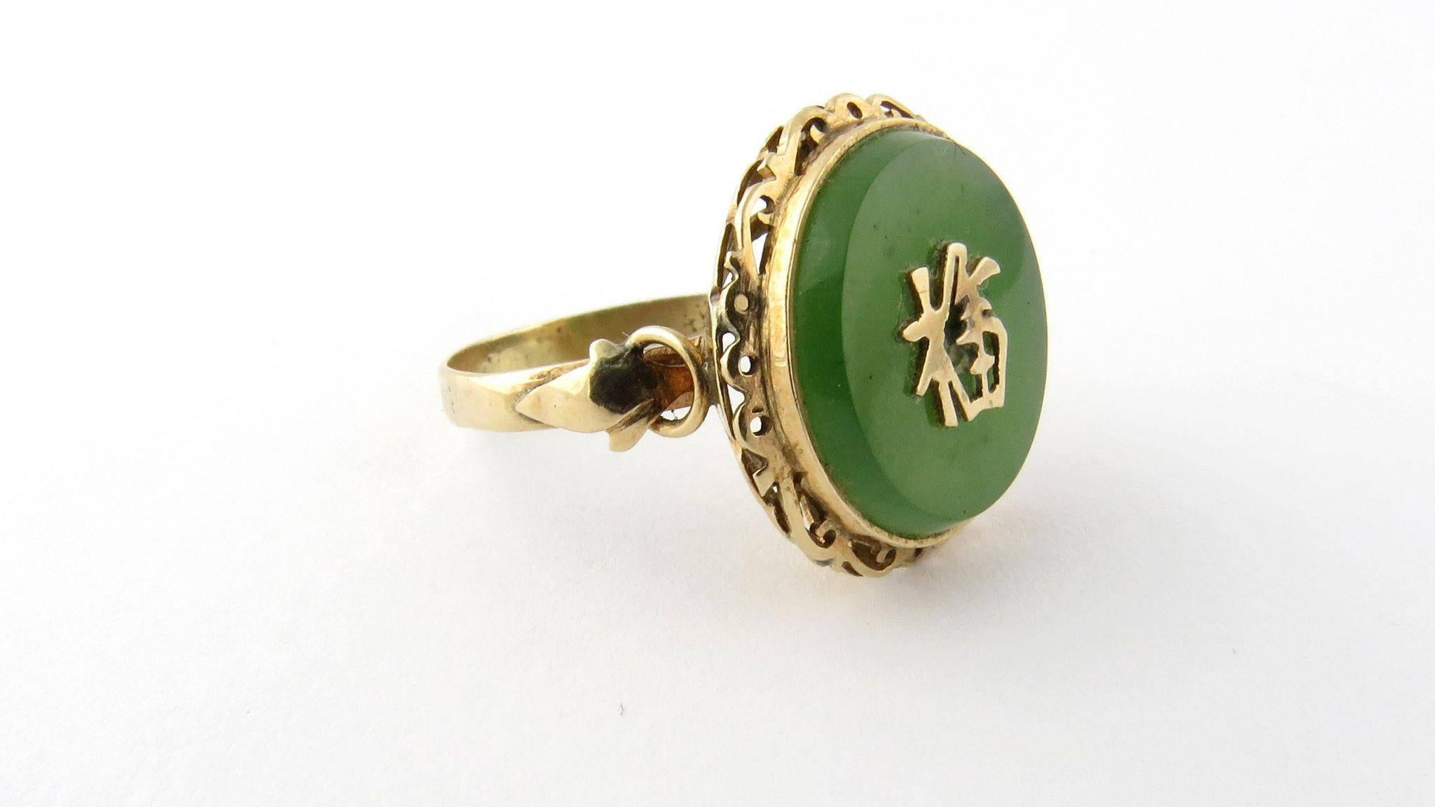 Vintage 14K Yellow Gold and Jade Good Fortune Ring Size 5.75 

This beautiful ring is set with the symbol for good fortune in gold atop a circle of green jade. 

Jade is 15 mm in diameter. Front of ring is 18 mm in diameter. 

Shank is 2.5 mm.