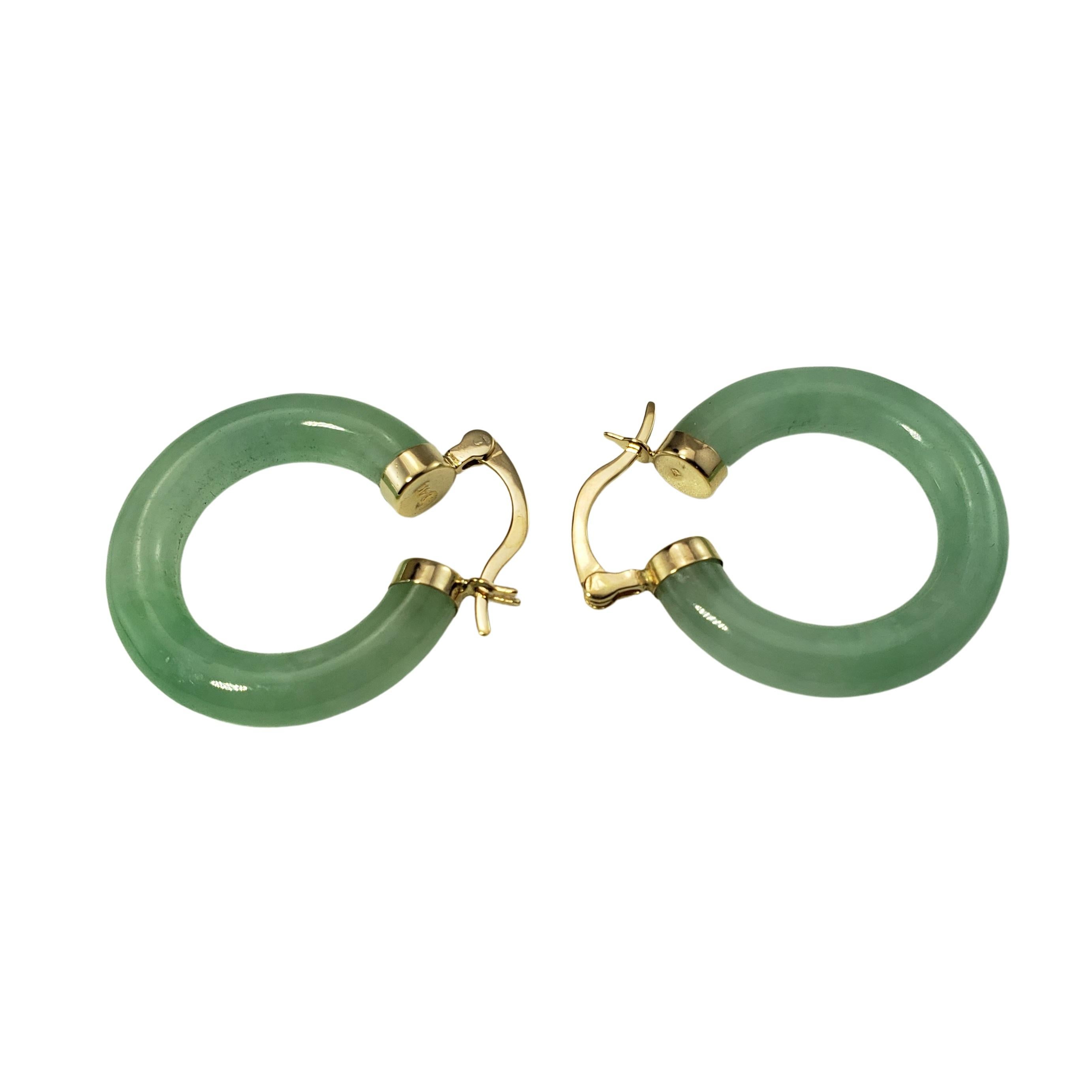 14 Karat Yellow Gold and Jade Hoop Earrings-

These lovely hoop earrings are crafted in beautifully detailed jade and accented with 14K yellow gold closures.  Width:  5 mm.

Size: 25 mm

Weight:  4.6 dwt. /  7.3 gr.

Stamped: 14K

Very good