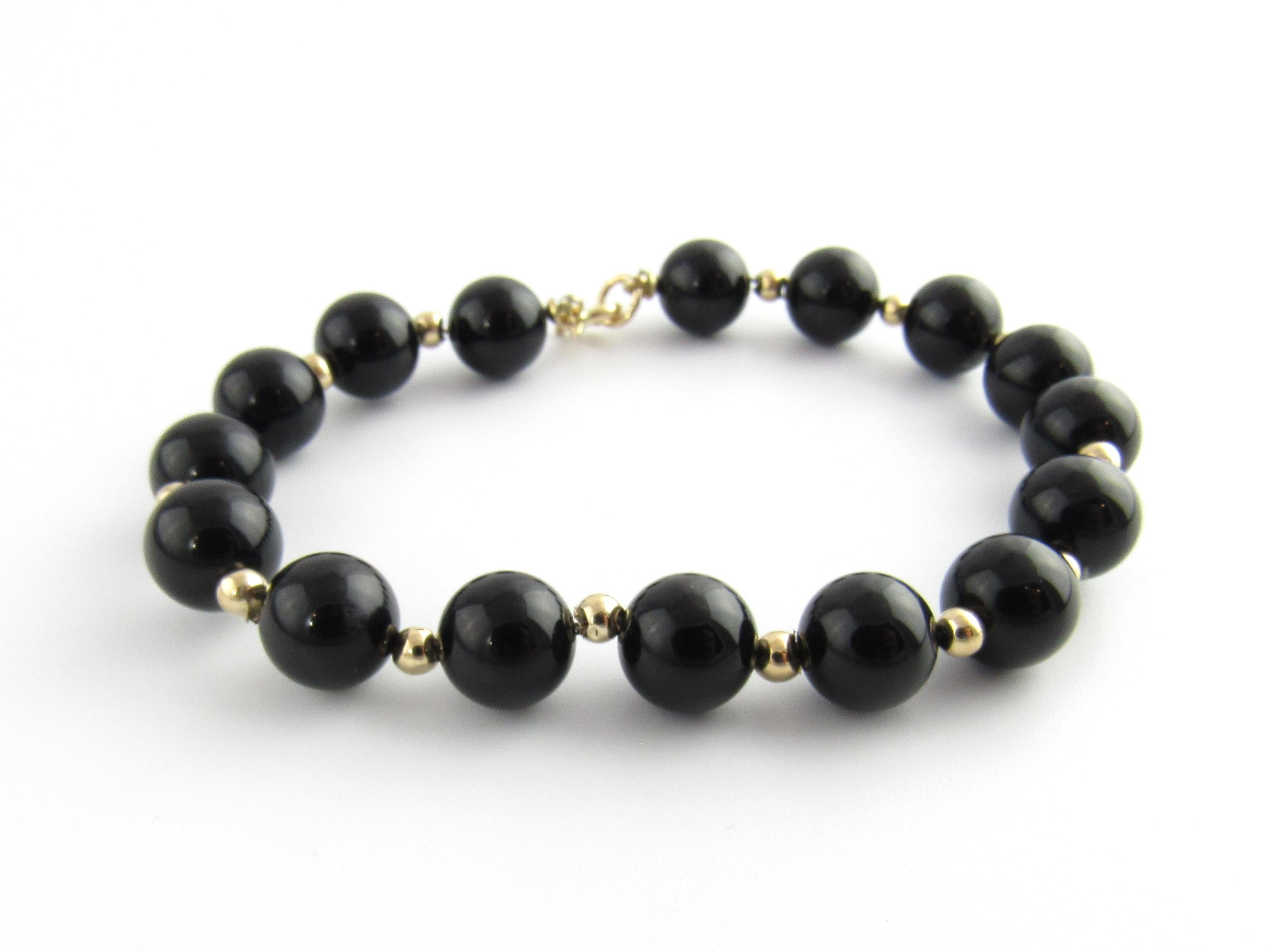 Vintage 14 Karat Yellow Gold Onyx Bead Bracelet

This elegant bracelet features 15 black onyx beads (8 mm each) accented with 15 polished gold beads crafted in 14K yellow gold. Spring ring closure.

Size: 6.25 inches

Weight: 7.7 dwt. / 12.0