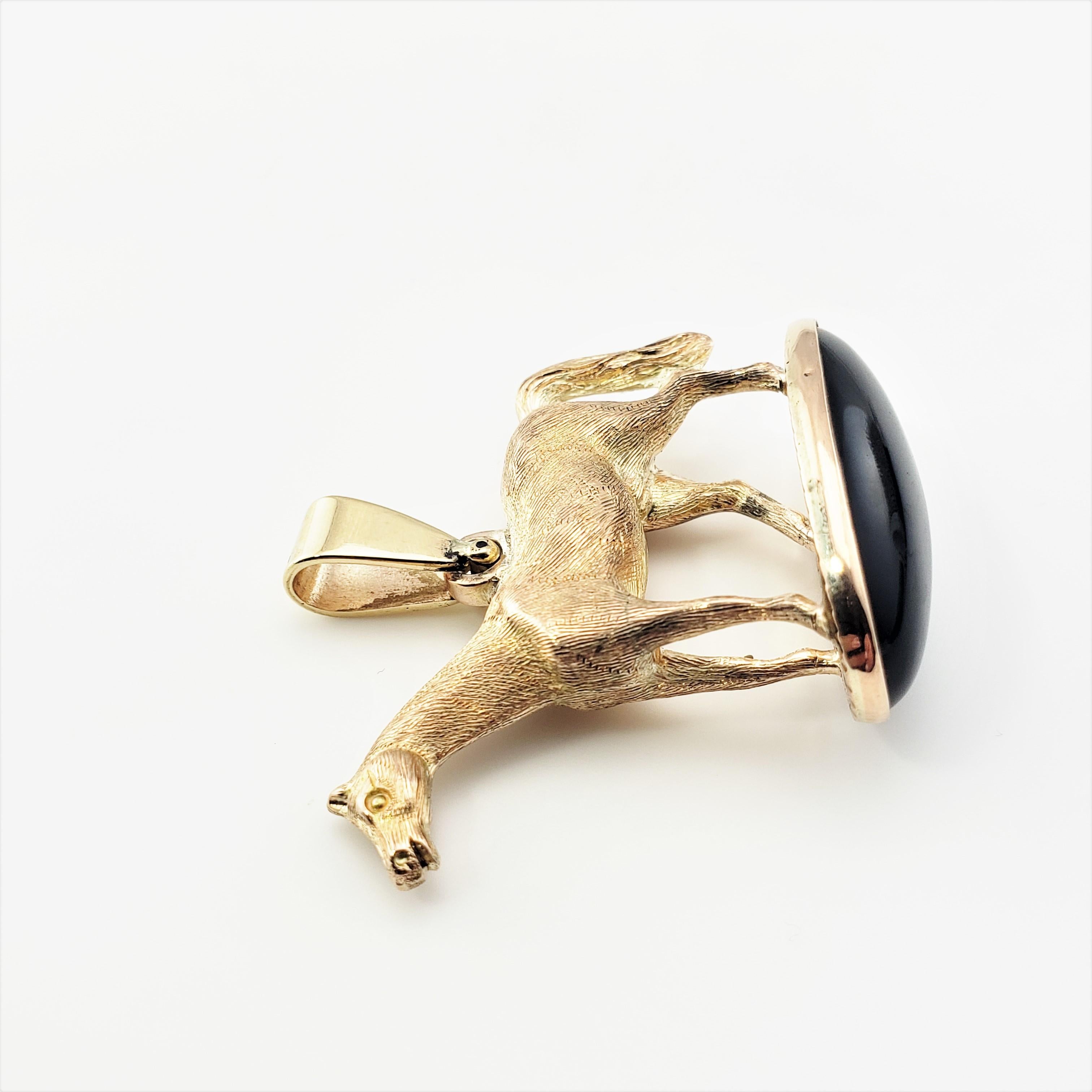 Oval Cut 14 Karat Yellow Gold and Onyx Horse Pendant For Sale