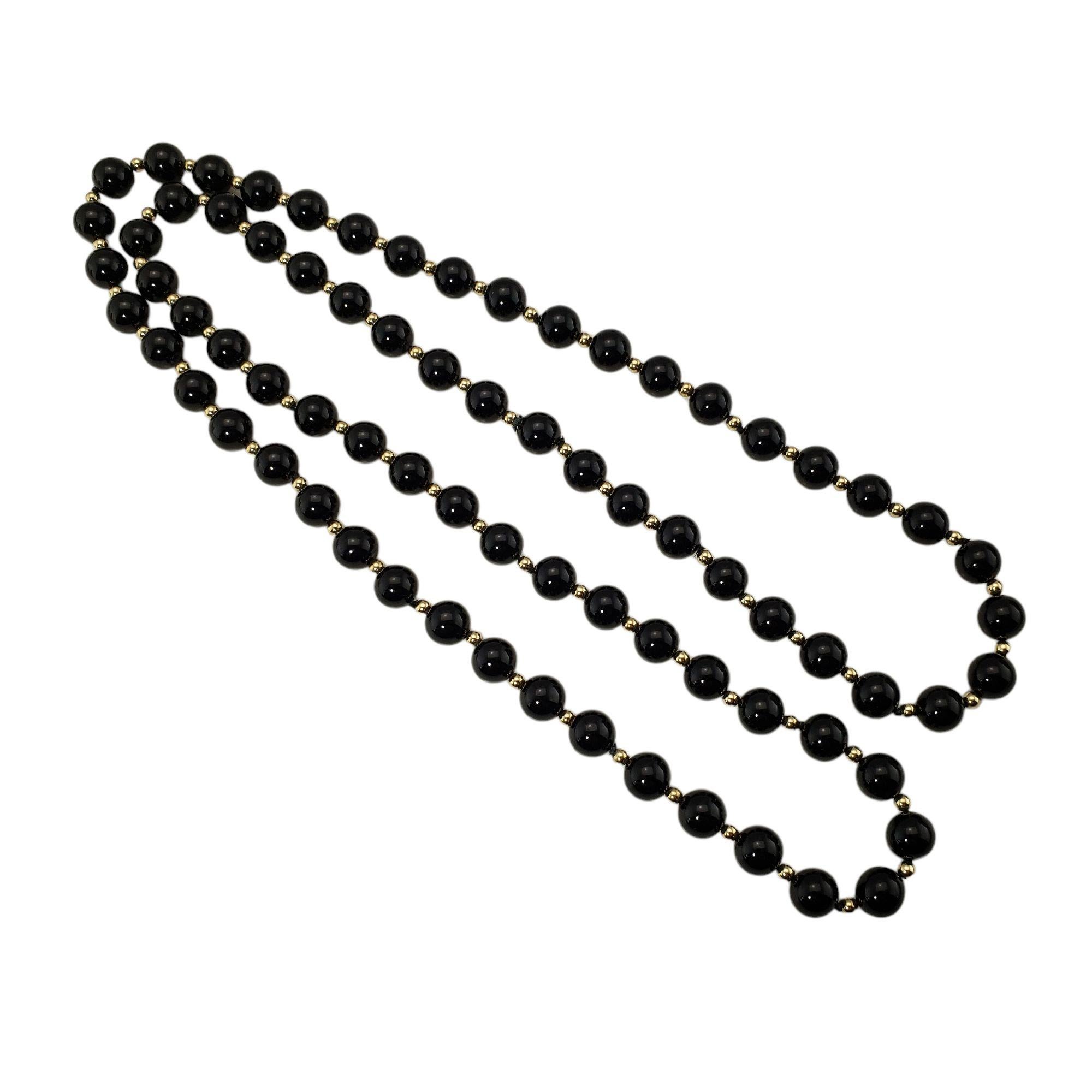 Vintage 14 Karat Yellow Gold and Onyx Necklace-

This lovely 14K yellow gold necklace features 74 round onyx beads (8 mm each).

Size: 31 inches

Weight: 33.4 dwt. / 52.0 gr.

Tested 14K gold.

Very good condition, professionally polished.

Will