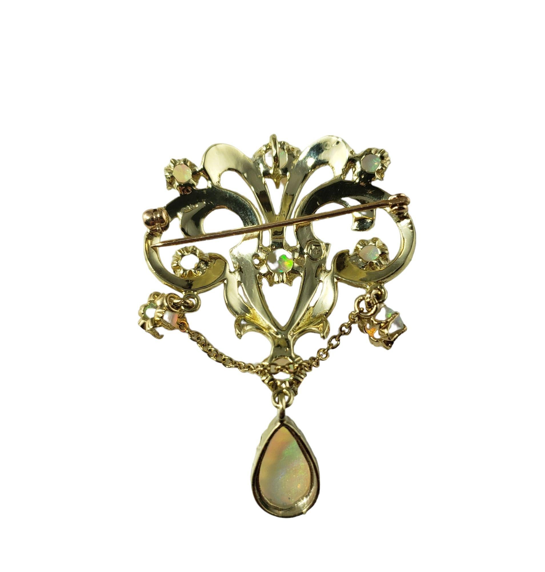 Vintage 14 Karat Yellow Gold and Opal Brooch/Pendant-

This lovely piece features 32 opals set in beautifully detailed 14K yellow gold. Can be worn as a brooch or a pendant.

Size: 52 mm x 31 mm

Weight: 11.5 gr./ 7.3 dwt.

Very good condition,