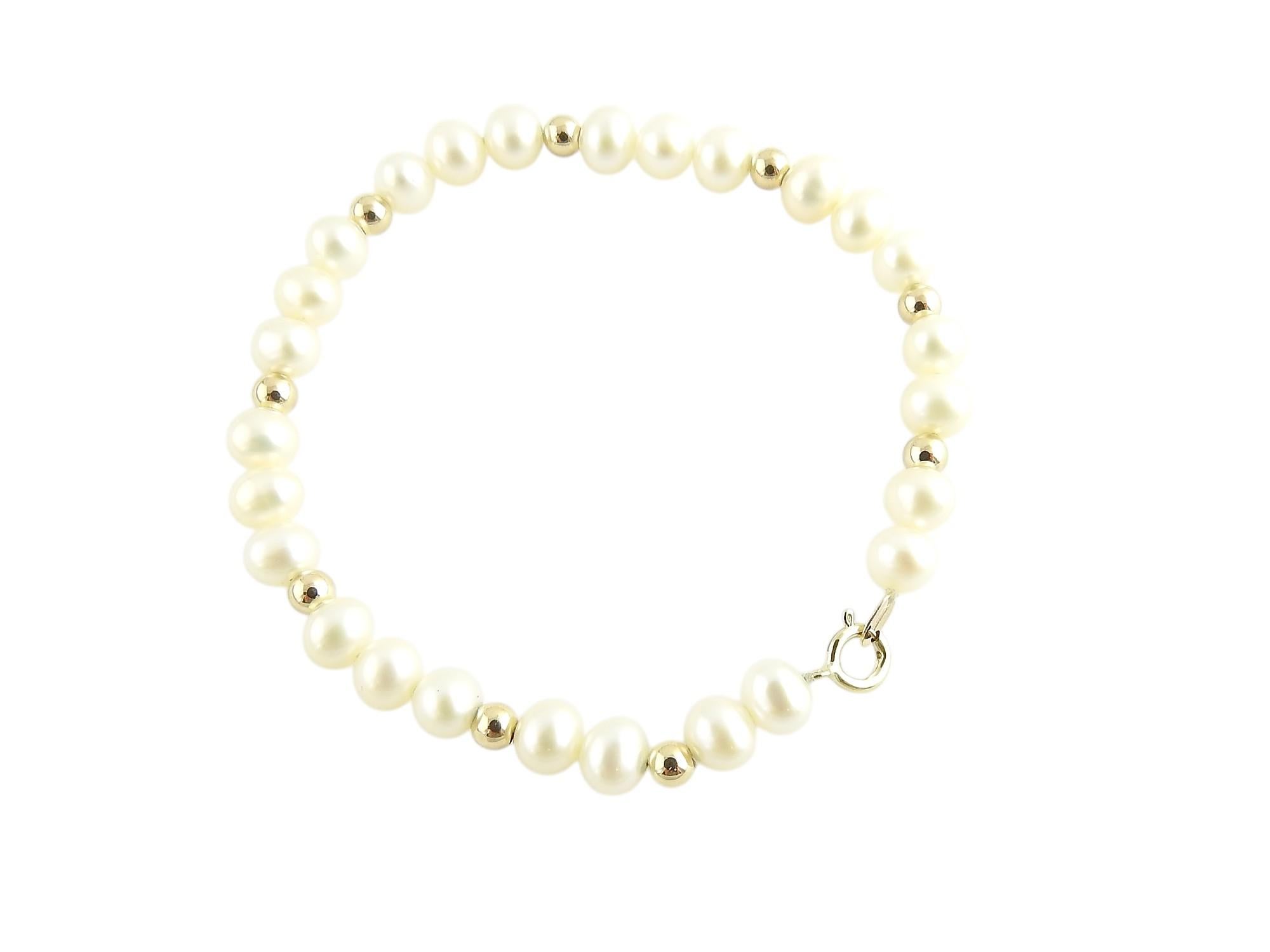 This lovely bracelet features 26 round pearls (5 mm each) and nine delicate 14K gold beads. Spring ring closure.

Size: Fits up to a 5.25 inch wrist. very small size

Weight: 2.4 dwt. / 3.8 gr.

Stamped: 14K

Very good condition, professionally