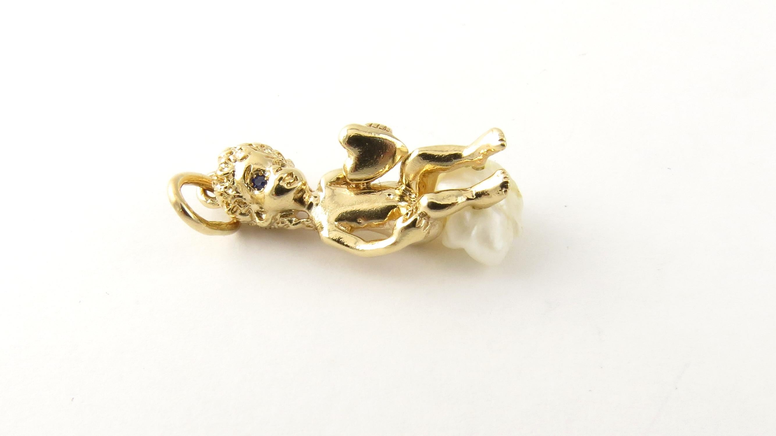 Vintage William Ruser 14 Karat Yellow Gold and Pearl Cherub Charm.

This adorable cherub sits atop a freshwater pearl meticulously crafted in 14K yellow gold.

Size: 27 mm x 10 mm (actual charm)

Weight: 3.6 dwt. / 5.6 gr.

Stamped: 14K Ruser

Very