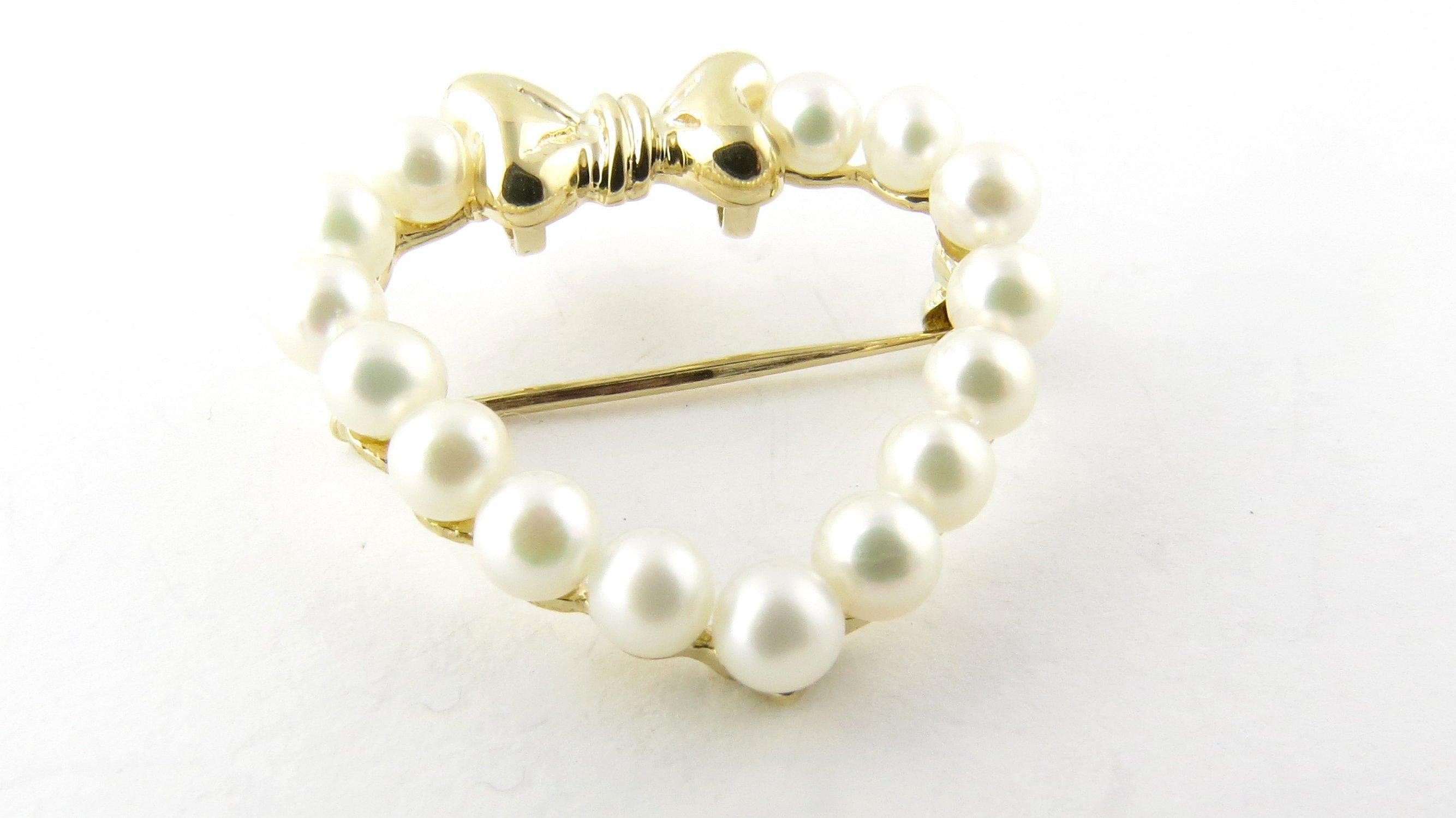 Vintage 14 Karat Yellow Gold and Pearl Heart Brooch/Pin- 
This stunning heart brooch is decorated with 15 lovely pearls (3 mm each) accented with a feminine bow detail and set in 14K yellow gold. 
Size: 25 mm x 25 mm 
Weight: 1.8 dwt. / 2.9 gr.