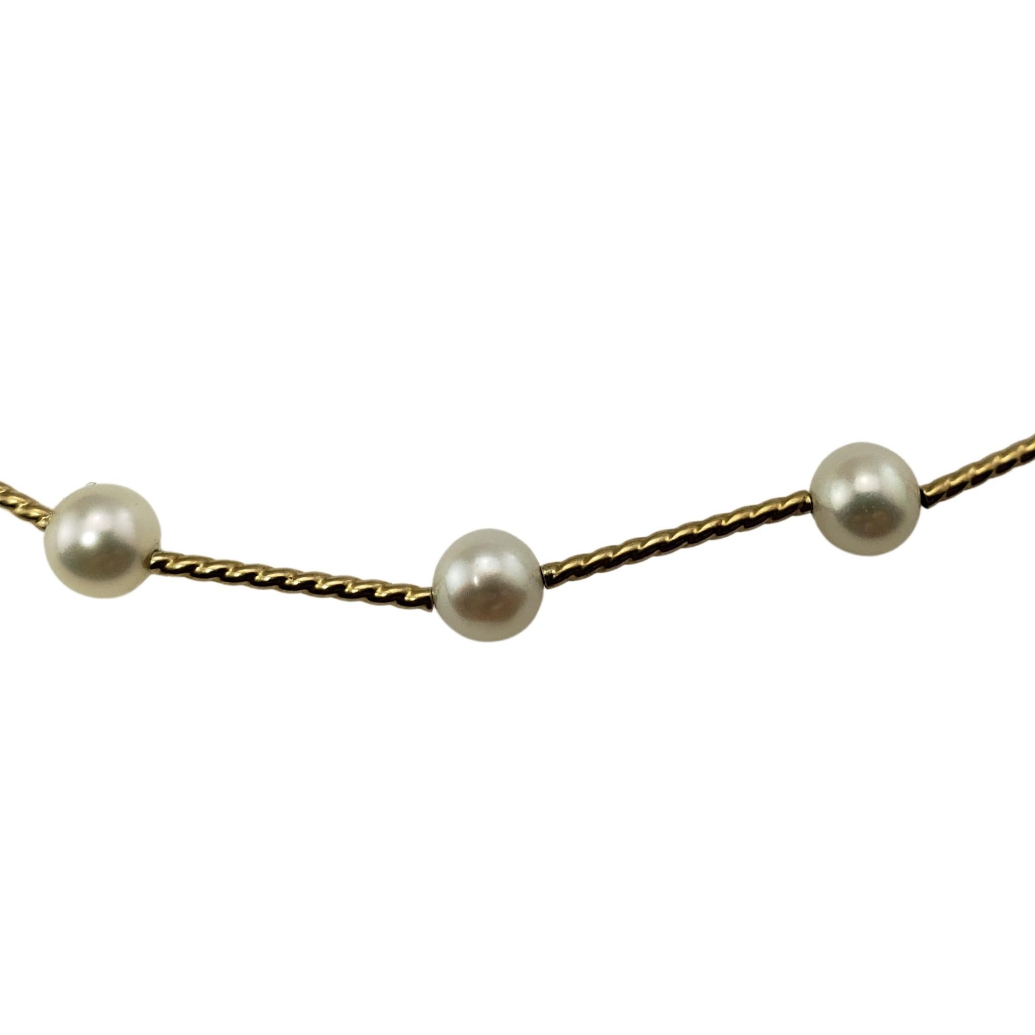 14 Karat Yellow Gold and Pearl Necklace-

This elegant necklace features 26 round white pearls (5 mm each) set on 14K yellow gold.

Size: 17.5 inches

Weight:  4.1 dwt. /  6.5 gr.

Stamped: 14K 

Very good condition, professionally polished.

Will