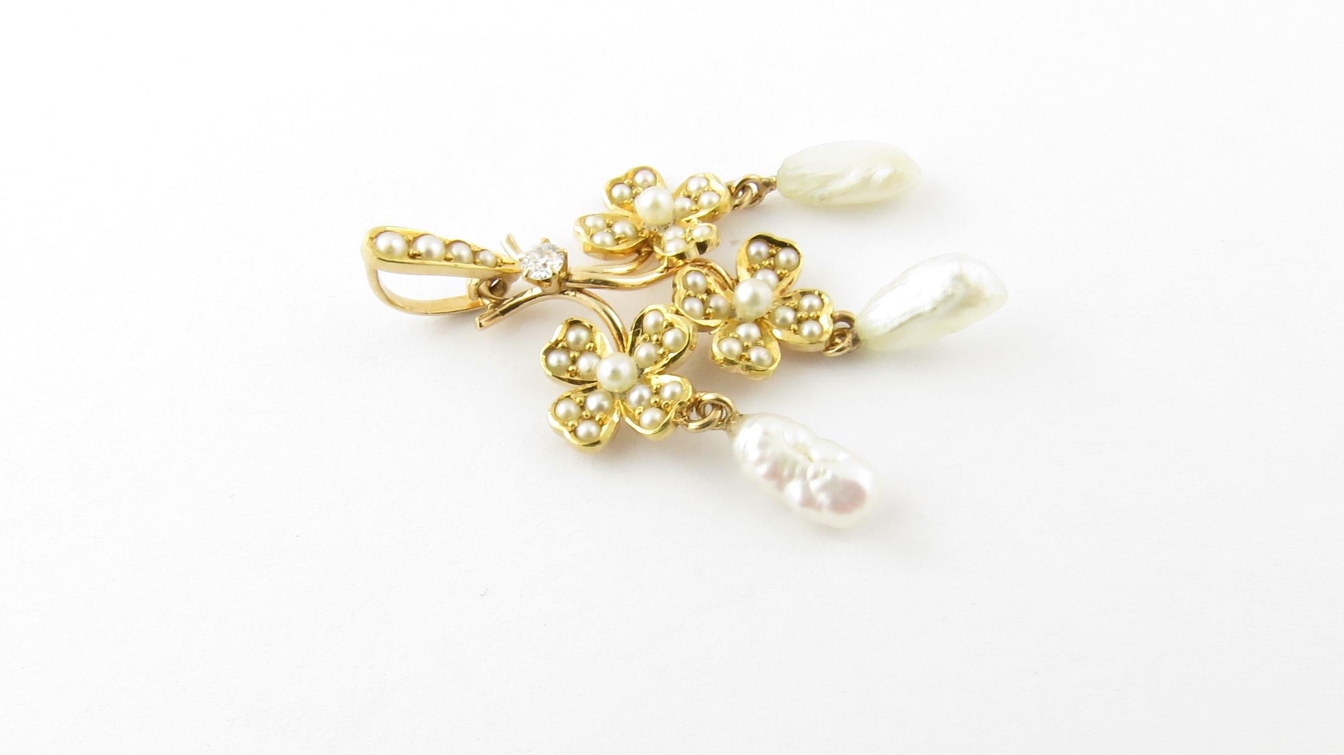 Vintage 14 Karat Yellow Gold Diamond and Pearl Pendant.

This lovely pendant features 39 round pearls and three dangling freshwater pearls set in beautifully detailed 14K yellow gold.

One round brilliant diamond of VS2 clarity and G color, .02