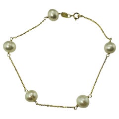 Bracelet station en or jaune 14 carats et perles n°13324