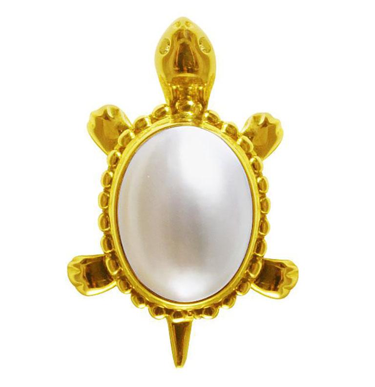 Estate turtle-shaped pin in 14k yellow gold with eyes set in diamonds and a pearl shell. The two diamonds weigh a total of 0.04cttw and the pearl weighs 5.1gms.