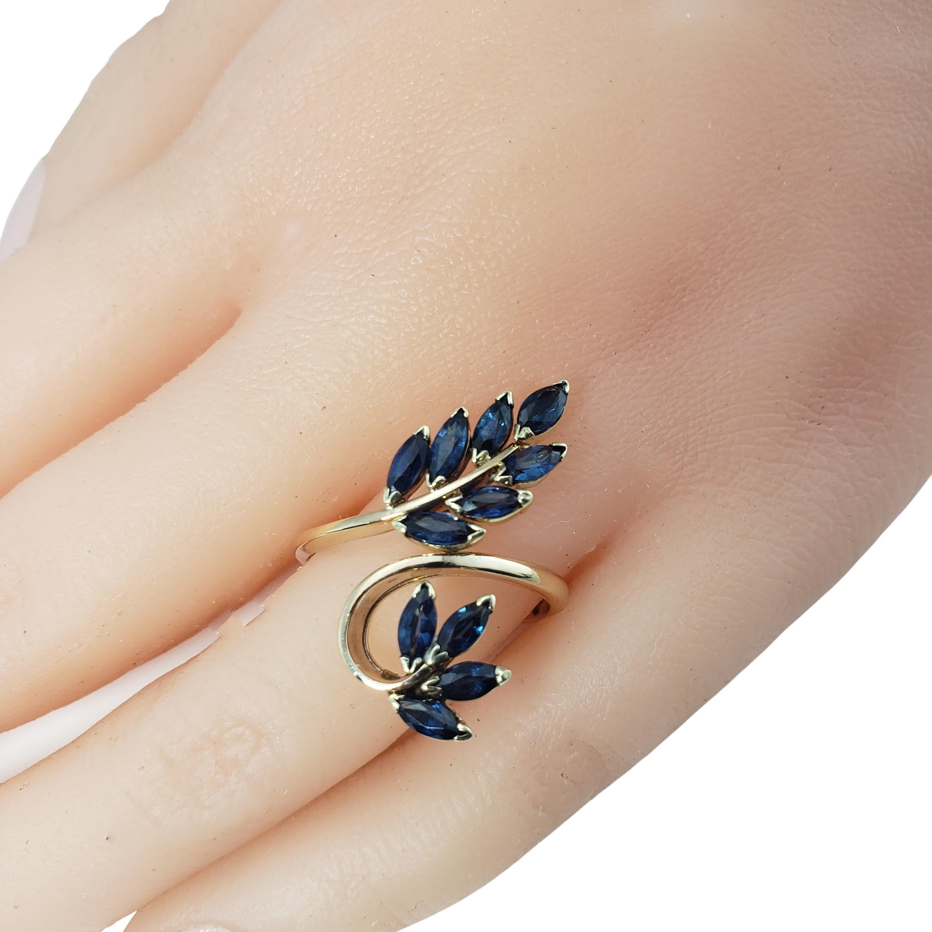 Vintage 14 Karat Yellow Gold and Sapphire Ring Size 9 -

This stunning 14K yellow gold ring features 11 marquis sapphires (5 mm x 3 mm each) set in a lovely leaf design. Width: 25 mm.
Shank: 2 mm.

Ring Size: 9

Weight: 2.7 dwt. / 4.2 gr.

Stamped: