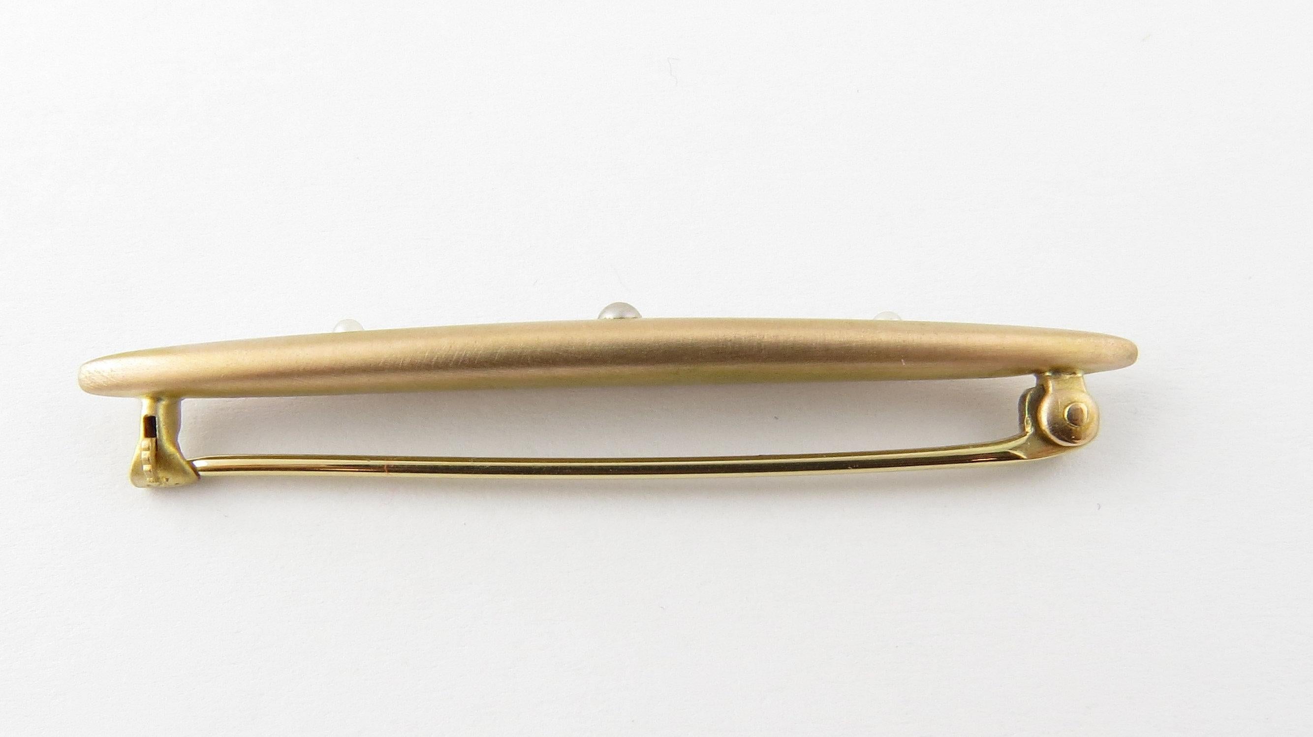 Vintage 14 Karat Yellow Gold and Seed Pearl Brooch/Pin- 
This lovely pin features three tiny seed pearls set in stunning matte finish 14K yellow gold. 
Matching pins: RL-0003713 RL-0003705 
Size: 6 mm x 50 mm 
Weight: 1.9 dwt. / 3.0 gr. 
Hallmark: