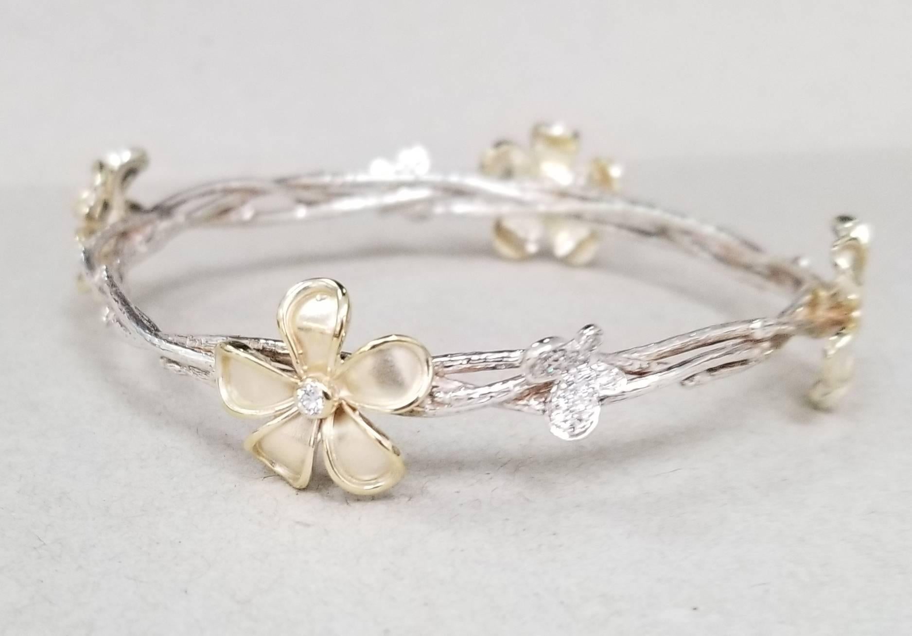 14k yellow gold flowers with diamonds weighing .50pts. on a silver 