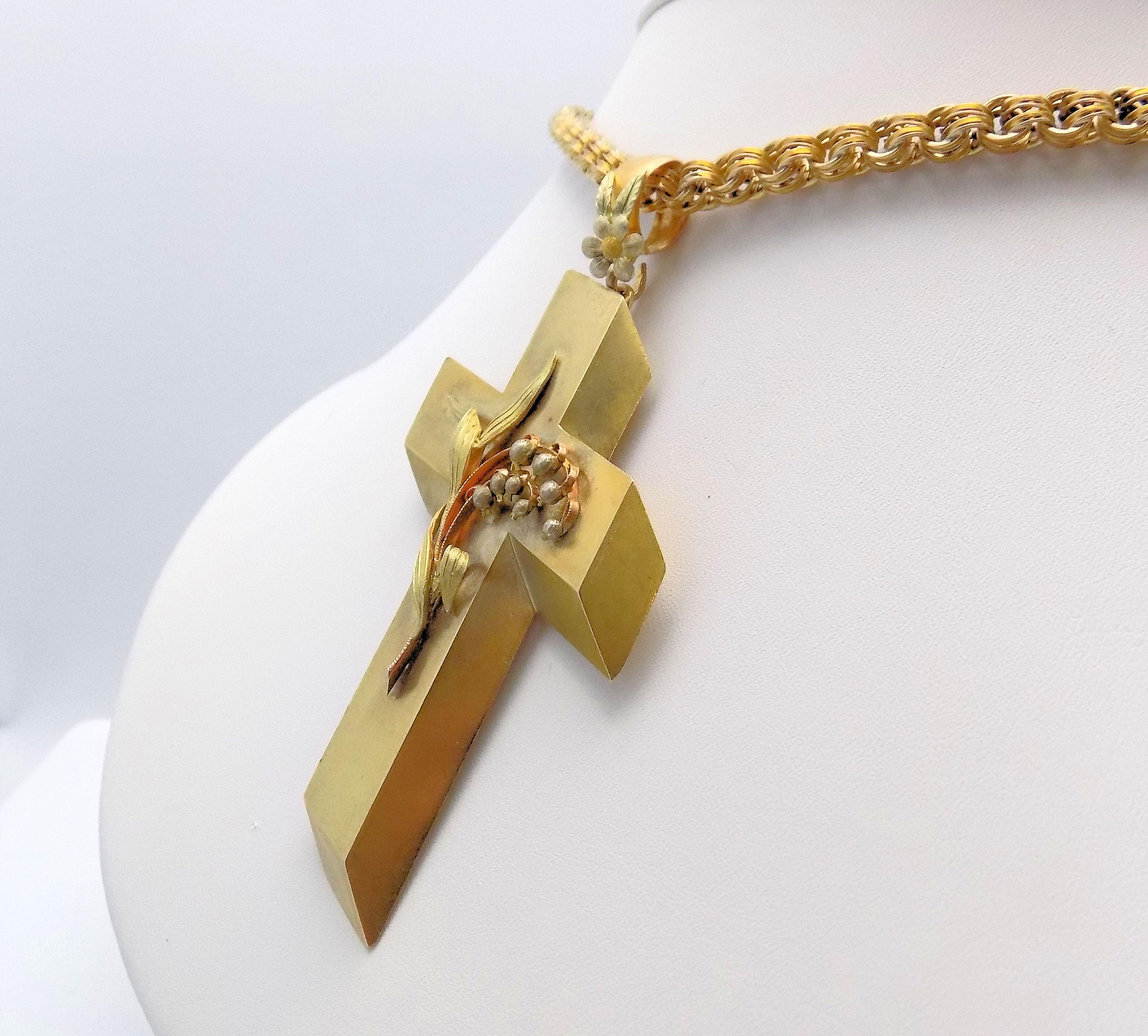 Awe-inspiring 14 Karat Yellow Gold Antique Cross Pendant & Chain.  Dramatic 3-D Effect on this Large Cross with Applied Lilly of the Valley Floral Motif, Excellent Condition; Chain Is Curved Link, Handmade, Several Repairs on Chain (Good Condition).