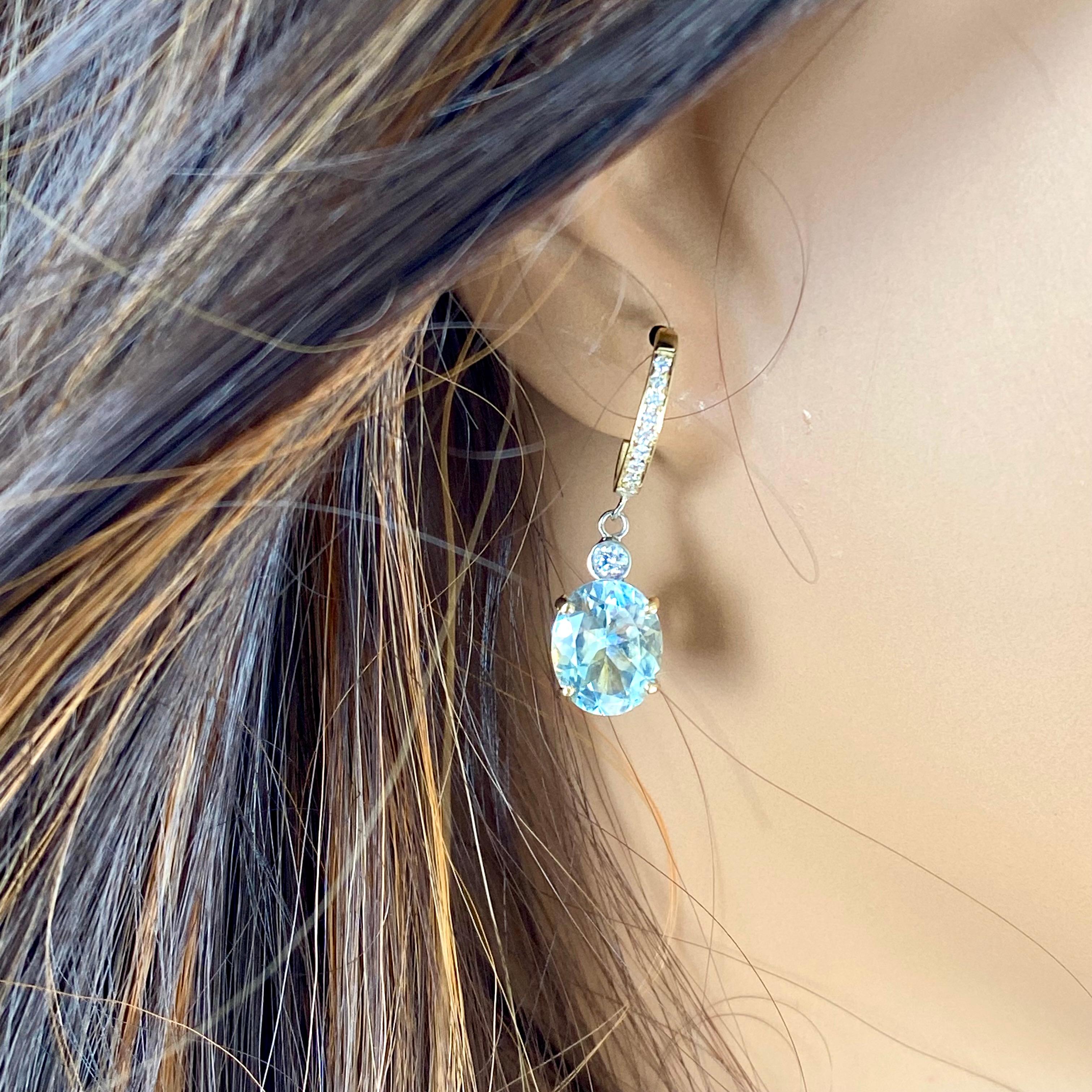 Introducing our exquisite 14 Karat Yellow Gold Aquamarine and Diamond Hoop Earrings, a stunning testament to elegance and sophistication. Crafted with meticulous attention to detail, these earrings are designed to captivate admirers with their