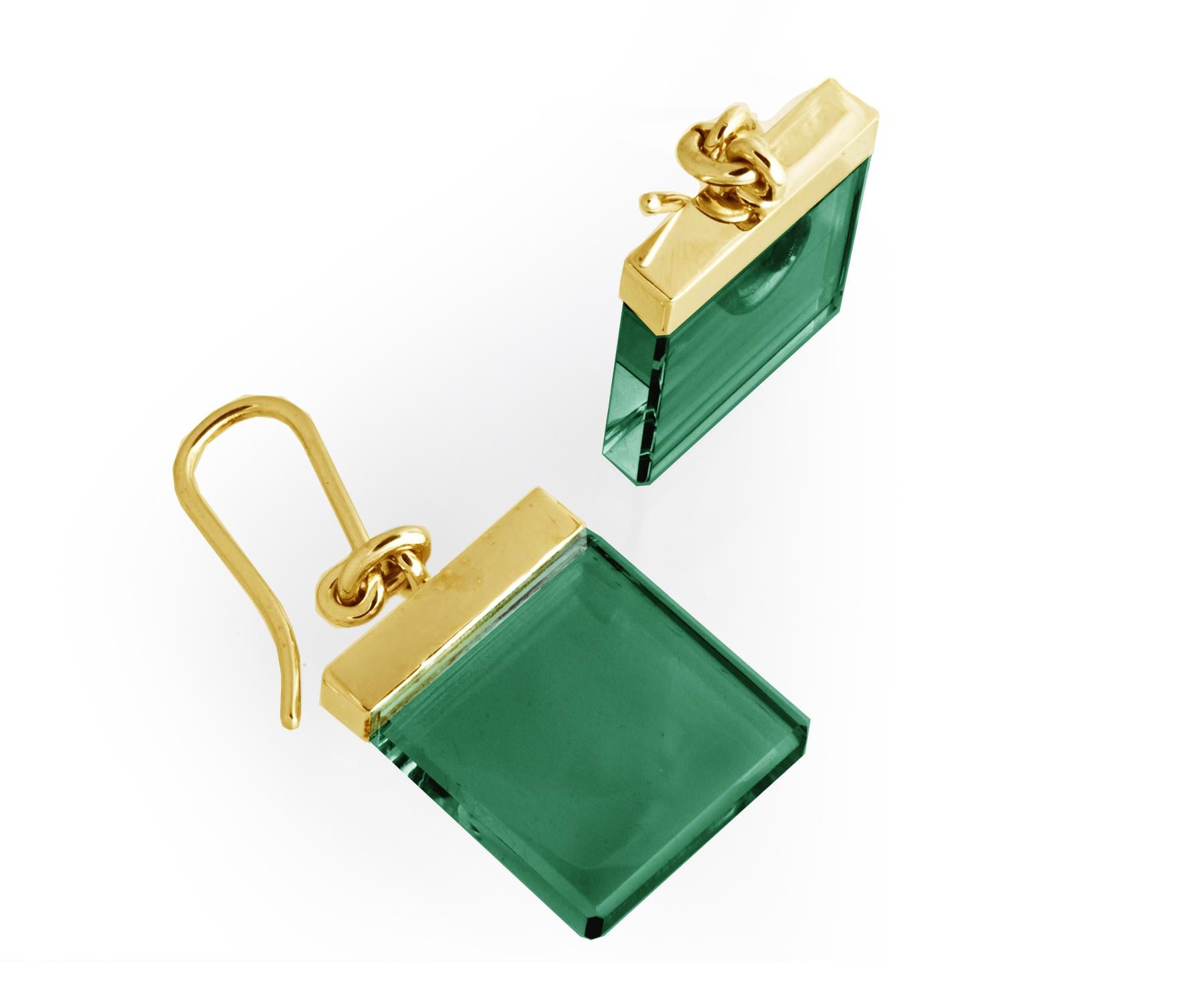 These fashion earrings belong to the Ink collection, a contemporary jewelry line designed by the Berlin-based oil painter Polya Medvedeva. They are crafted from 14 karat yellow gold and feature 15x15x3 mm green grown quartzes, which are cut in a way