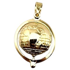 Ciondolo a forma di globo articolato in oro giallo 14 carati #23049