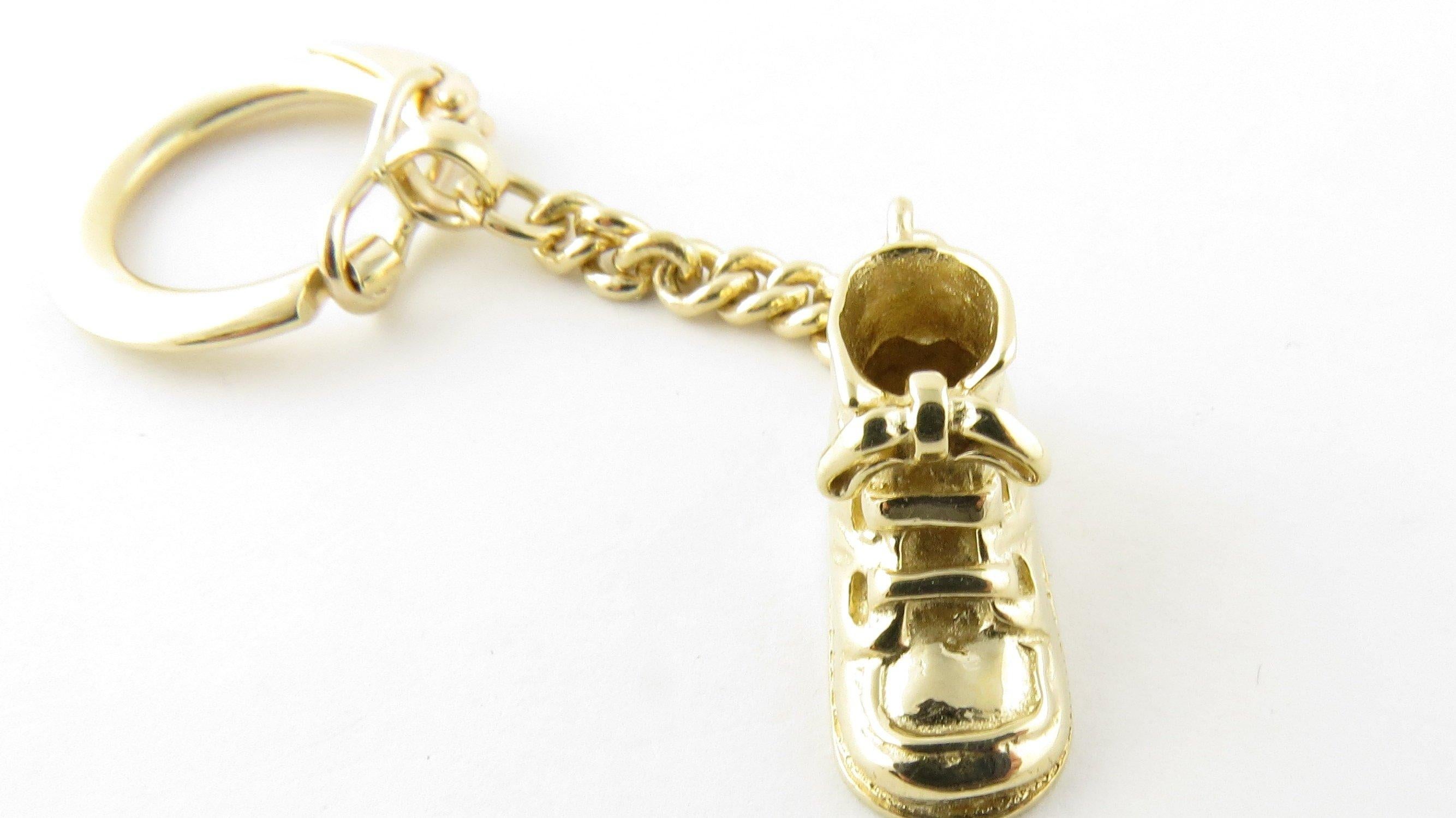 Vintage 14 Karat Yellow Gold Baby Shoe Keychain. This lovely keychain features a 3D baby shoe suspended from a classic 14K yellow gold key ring. Crafted in polished 14K yellow gold. Size: Key ring: 19 mm Baby shoe: 11 mm x 19 mm Chain: 33 mm Weight:
