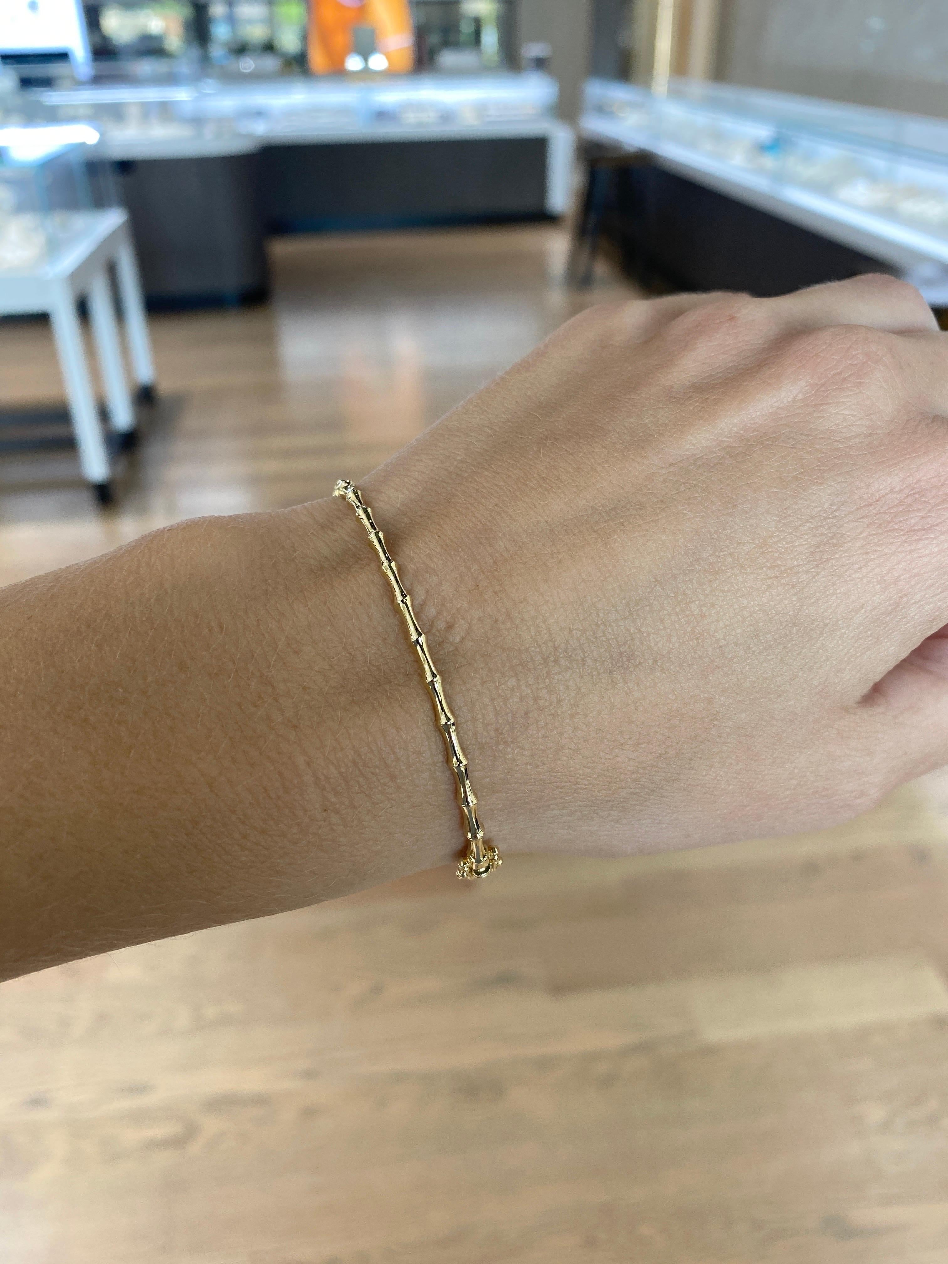 This beautiful bangle features a bamboo motif crafted in 14 karat yellow gold. You can wear along or layer with your favorite bracelets. Box clasp & double safety clasp closure. 
Measurements: Inner diameter approximately 57mm. Width 2.5mm