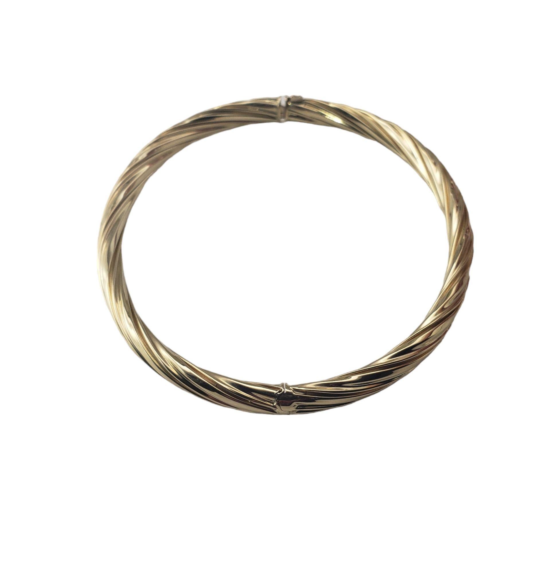 Vintage 14 Karat Yellow Gold Bangle Bracelet-

This lovely bangle bracelet is crafted in beautifully detailed 14K yellow gold. Width: 6 mm.

Size: 7 inches 
     
Weight: 9.4 gr./ 6.1 dwt.

Stamped: 14K

Very good condition, professionally