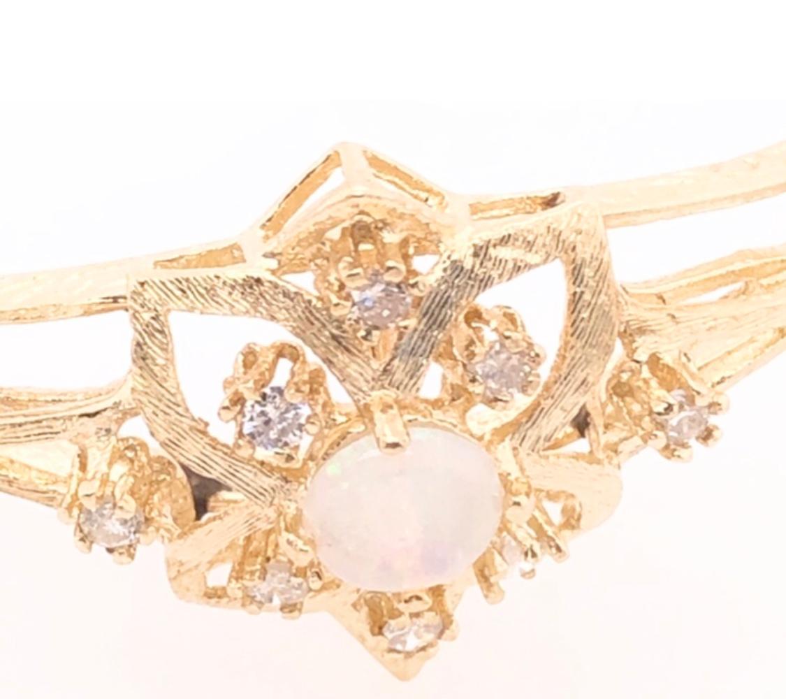 14 Karat Yellow Gold Bangle Bracelet with Center Opal and Diamond Accents
0.16 total diamond weight.
14.89 grams total weight.