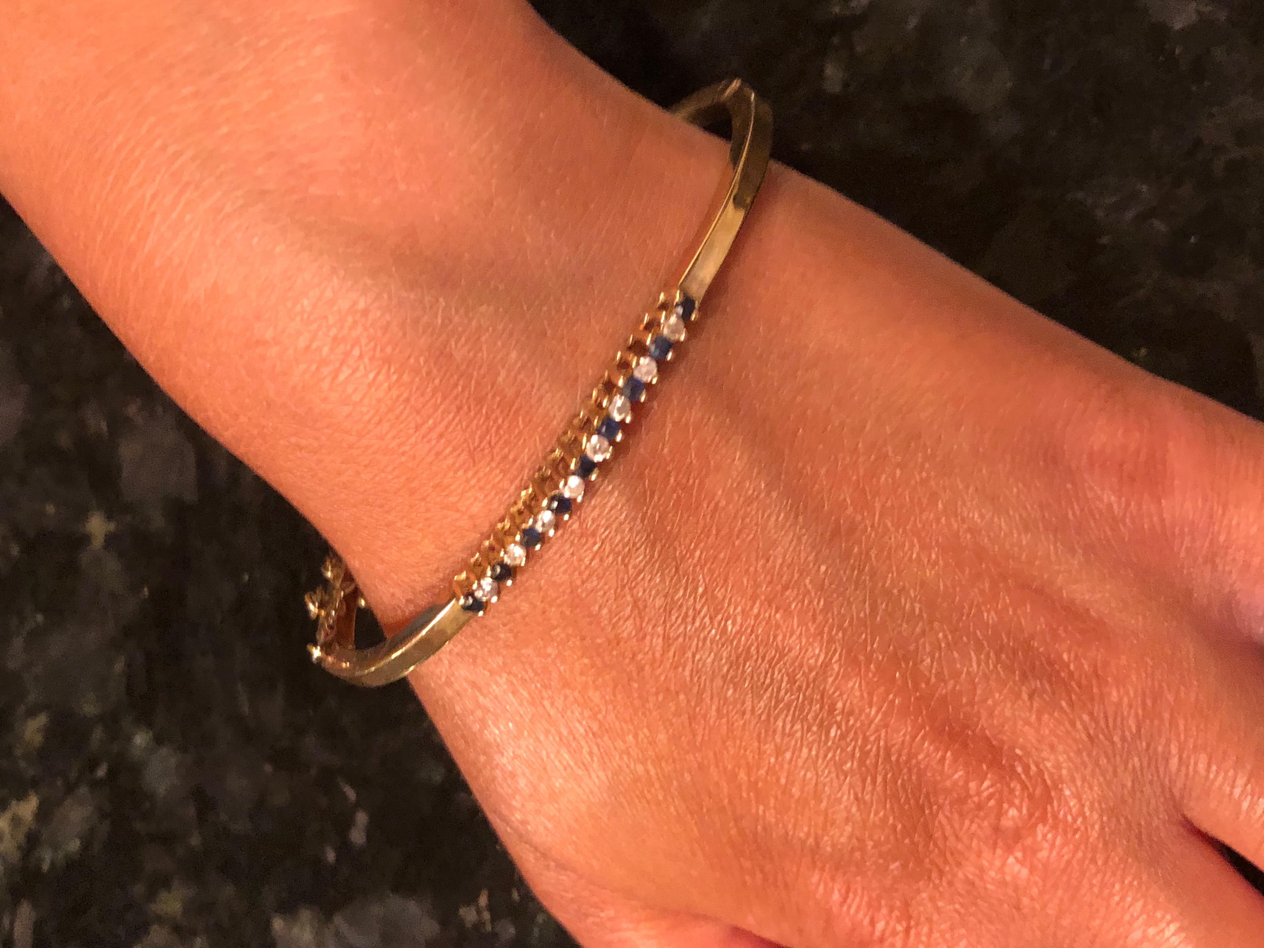 14 Karat Yellow Gold Fashion Bangle with sapphires and Diamonds.
0.25 total diamond weight.
7 grams total weight.
This is a stunning bracket with a quality lock on it. The diameter of the bracelet is 8 inches. 
