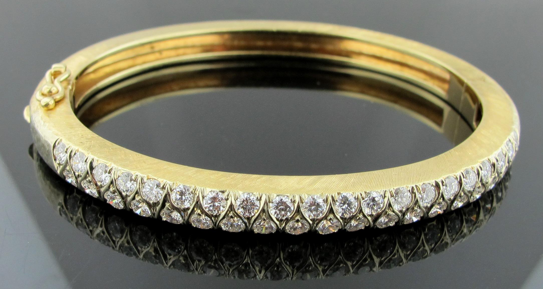 14 karat yellow gold bangle, with a gold weight of 33 grams, set with 40 round brilliant diamonds, weighing 2.00 carats. F-G in Color, VS in Clarity