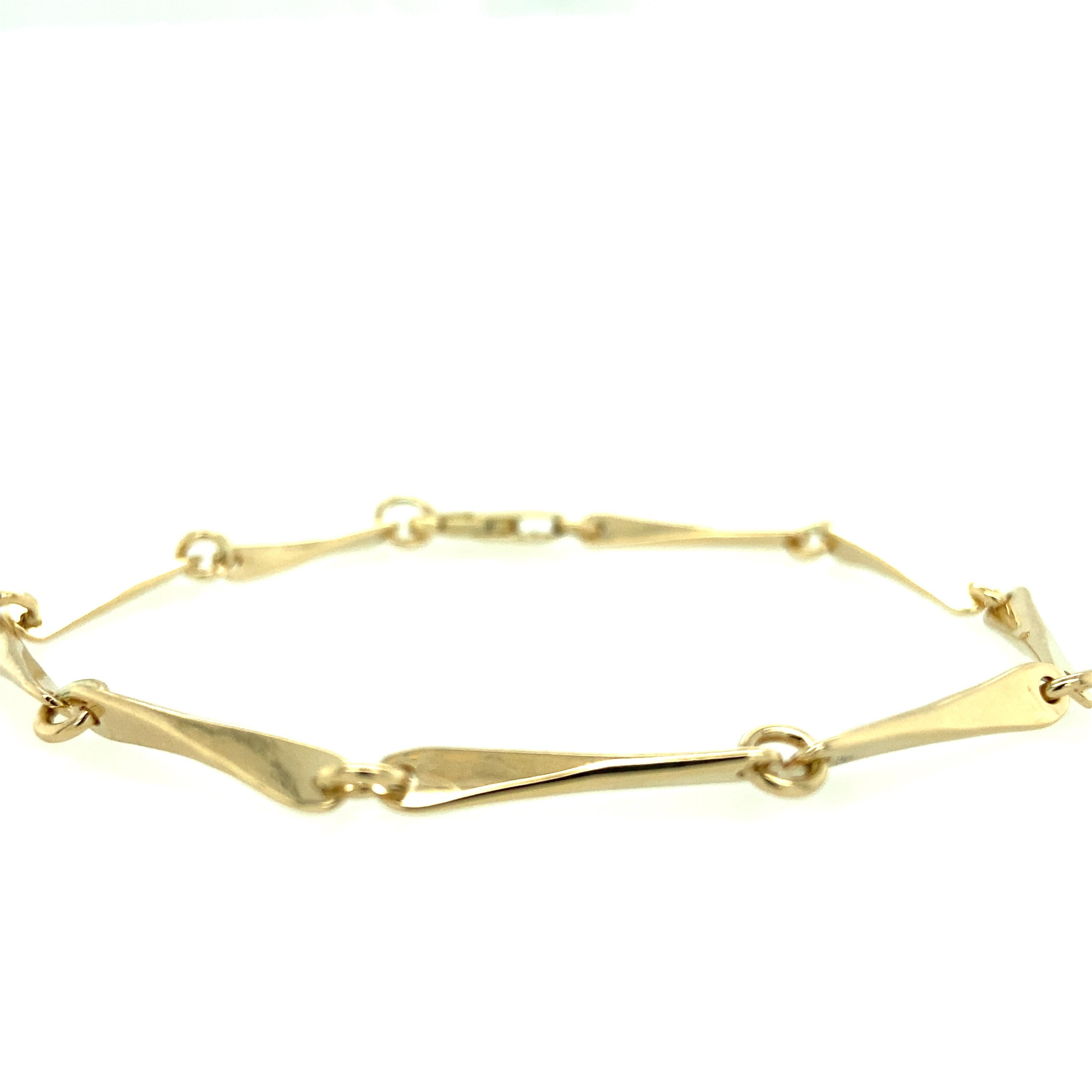 One 14 karat yellow gold (stamped 585) estate bar link bracelet measuring 7 3/4 inches and is complete with a lobster clasp. 